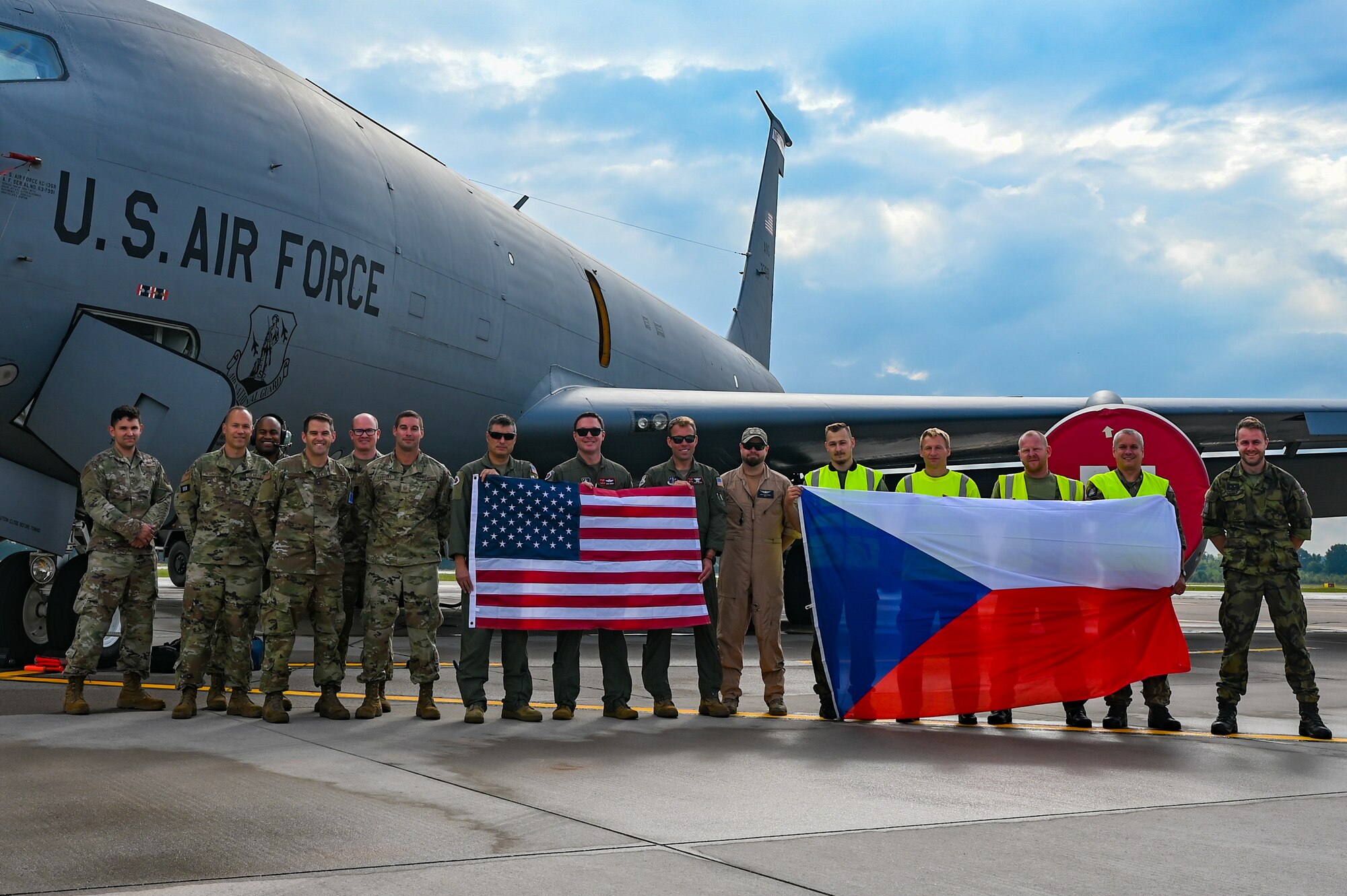 Air crew, maintainers and logistics Airmen with the 155th Air Refueling Wing, Nebraska Air National Guard, stand with Czech Air Force maintainers, holding their countries flags during exercise Ample Strike 2021, Sept. 16, 2021, at Pardubice Airport, Czech Republic. Ample Strike is a Czech Republic-led, multinational live exercise that offers advanced Air/Land Integration Training to Joint Terminal Attack Controllers in coordination with MQ-9 Reaper aircraft and F-15E Strike Eagle aircraft.