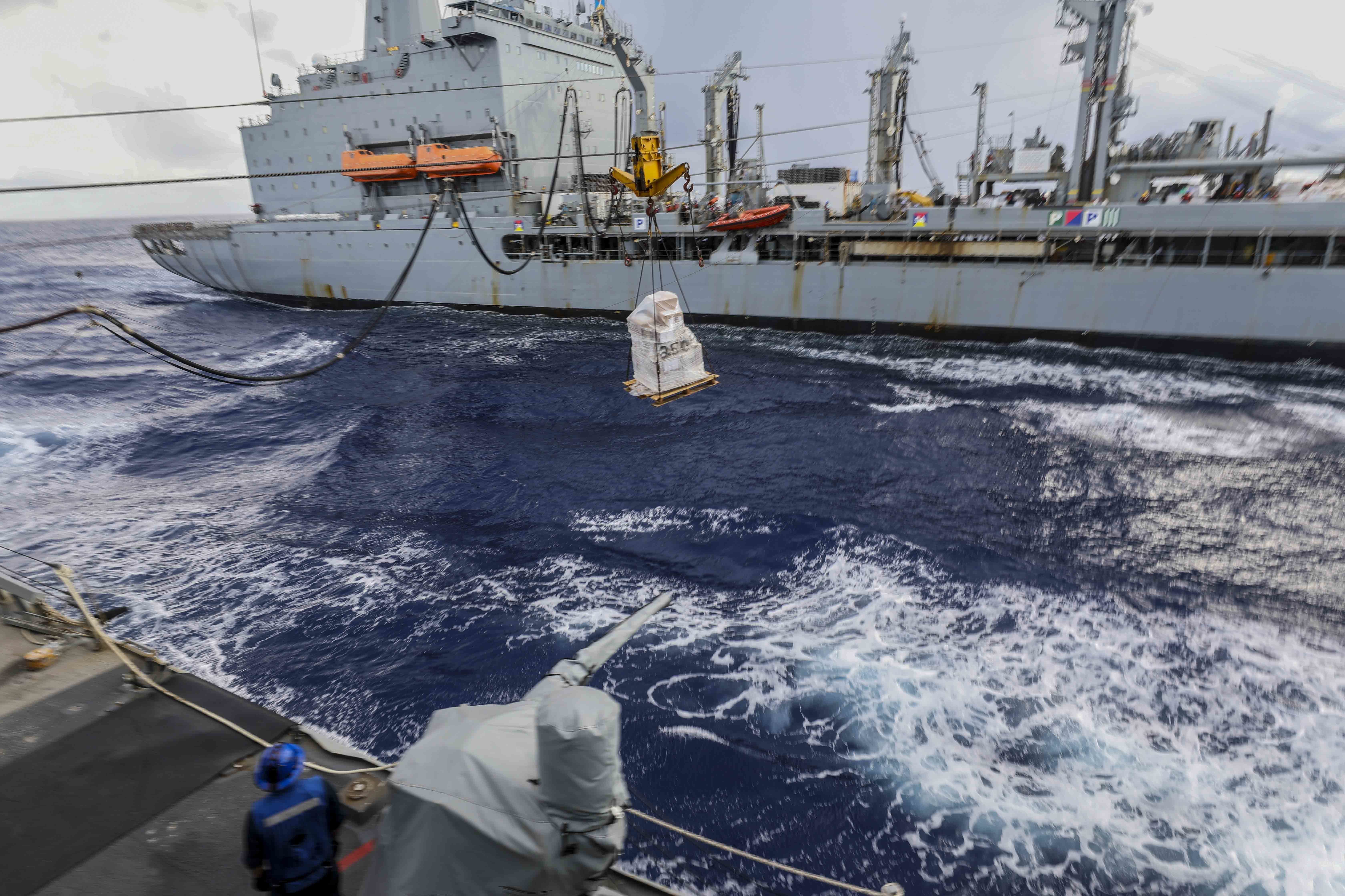 The Henry J. Kaiser-class underway replenishment oiler USNS Yukon (T-AO 202) delivers fuel and supplies to Arleigh Burke-class guided-missile destroyer USS Higgins (DDG 76) during a replenishment-at-sea.