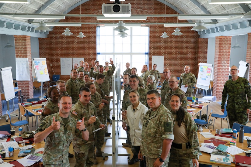 Participants for MREP 2022 work together on team building exercises at Camp Nymindegab July 4, 2022. MREP is a program that houses almost 130 participants from 6 different nations, to increase interoperability, strengthen partnerships, and to enhance professional development between allies.