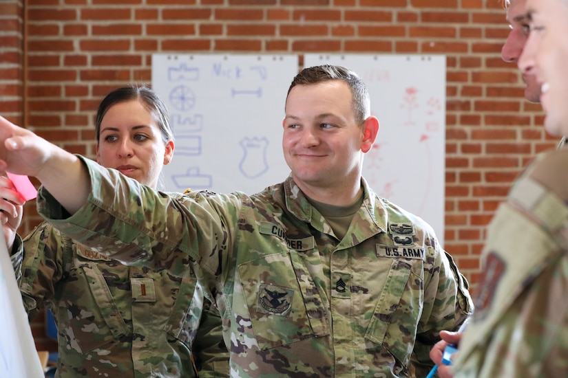 Participants for MREP 2022 work together on team building exercises at Camp Nymindegab July 4, 2022. MREP is a program that houses almost 130 participants from 6 different nations, to increase interoperability, strengthen partnerships, and to enhance professional development between allies.