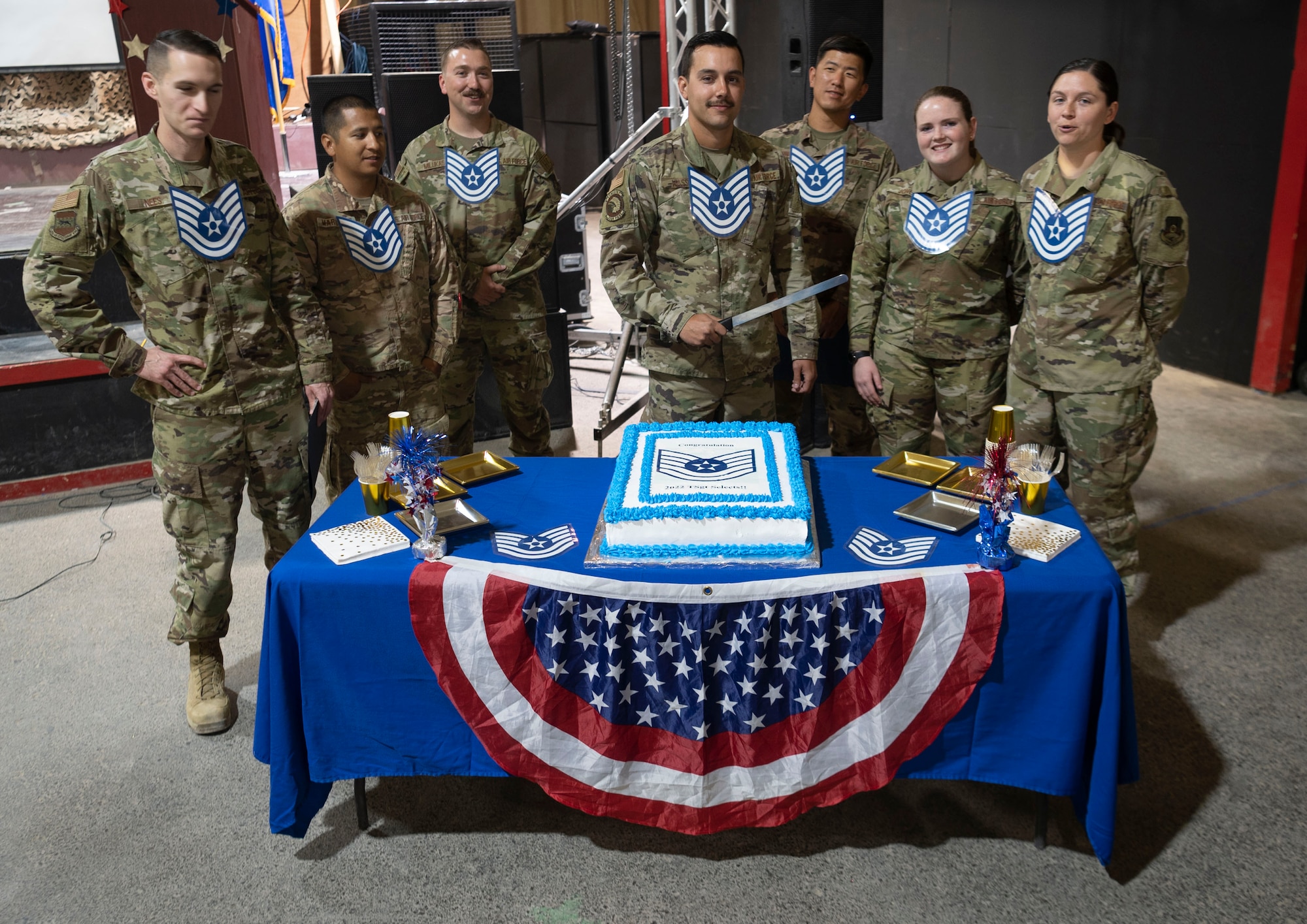 The 332d Air Expeditionary Wing celebrates with an E-6 release party for those Airmen selected to promote to Technical Sergeant at an undisclosed location in Southwest Asia, July 23, 2022. 332d AEW Commander Brigadier General R. Ryan Messer along with Command Chief Master Sergeant Kevin M. Eberlin help celebrate the occasion. Promotion to TSgt is very competitive, this year the promotion rate is only 16%. Promotions exemplify technical skills, leadership, and a standard of excellence. (U.S Air Force photo by Tech. Sgt. Jeffery Foster)