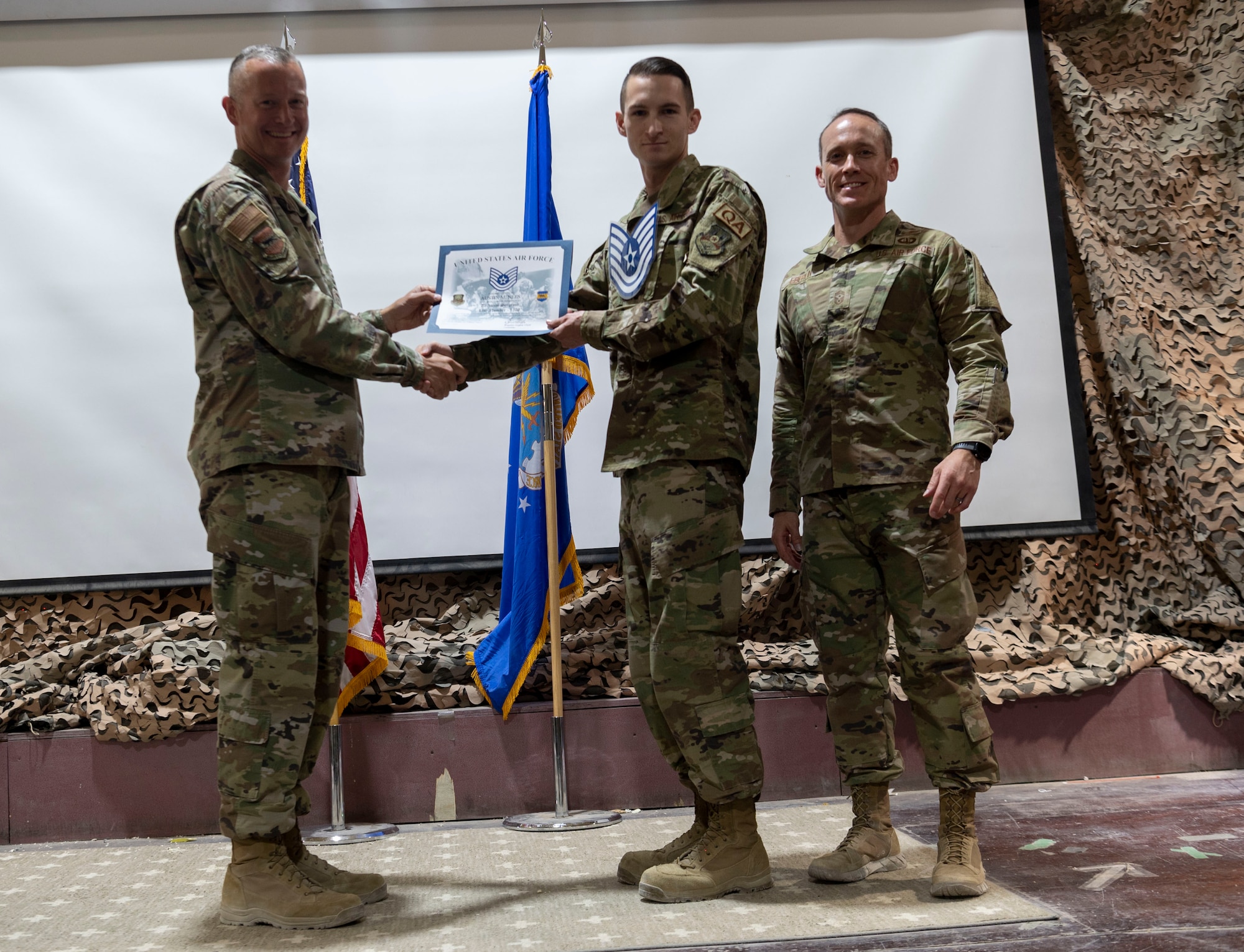 The 332d Air Expeditionary Wing celebrates with an E-6 release party for those Airmen selected to promote to Technical Sergeant at an undisclosed location in Southwest Asia, July 23, 2022. 332d AEW Commander Brigadier General R. Ryan Messer along with Command Chief Master Sergeant Kevin M. Eberlin help celebrate the occasion. Promotion to TSgt is very competitive, this year the promotion rate is only 16%. Promotions exemplify technical skills, leadership, and a standard of excellence. (U.S Air Force photo by Tech. Sgt. Jeffery Foster)