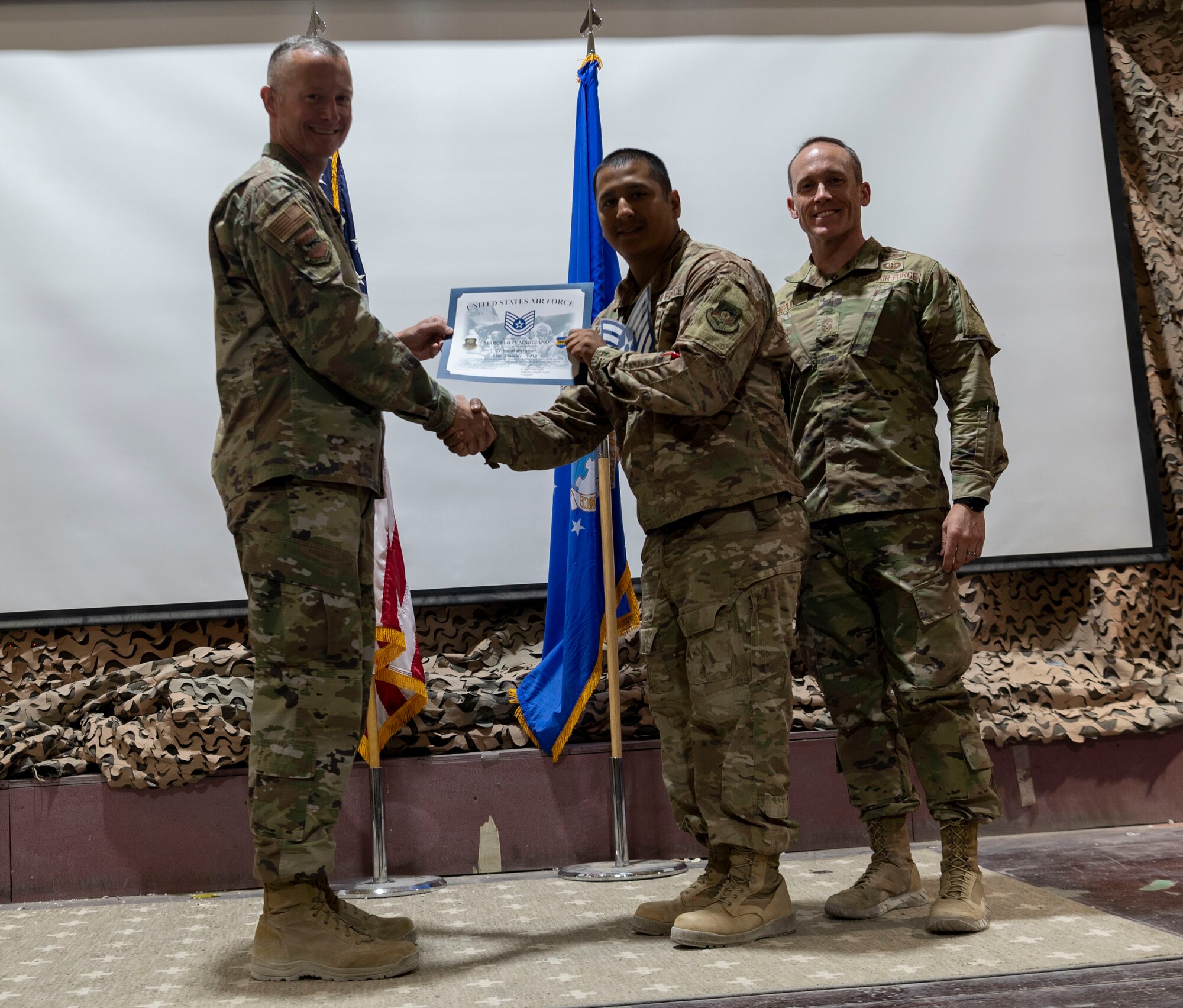 The 332d Air Expeditionary Wing celebrates with an E-6 release party for those Airmen selected to promote to Technical Sergeant at an undisclosed location in Southwest Asia, July 23, 2022. 332d AEW Commander Brigadier General R. Ryan Messer along with Command Chief Master Sergeant Kevin M. Eberlin help celebrate the occasion. Promotion to TSgt is very competitive, this year the promotion rate is only 16%. Promotions exemplify technical skills, leadership, and a standard of excellence. (U.S Air Force photo by Tech. Sgt. Jeffery Foster)