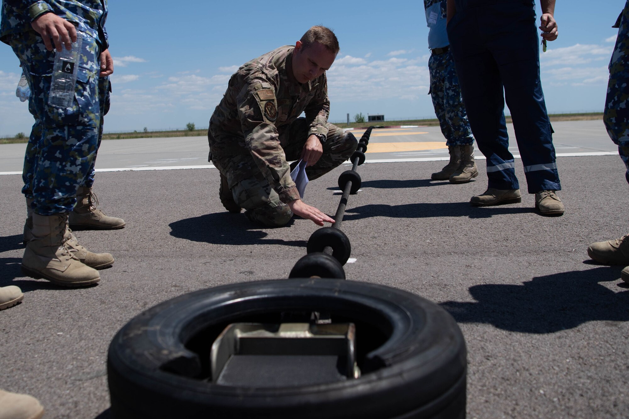 An airman checks a barrier arresting kit.