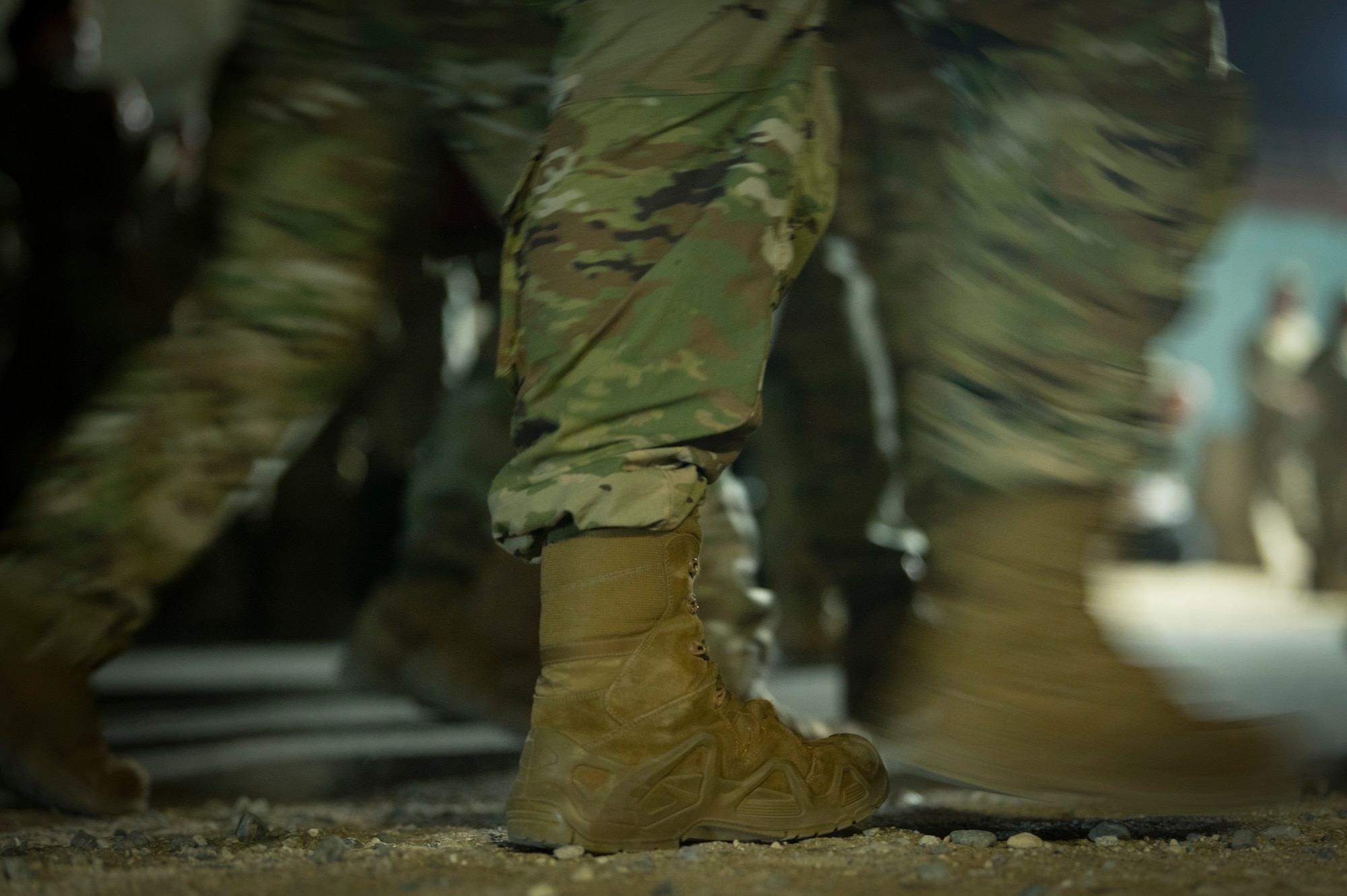 Airmen from the 386th Expeditionary Force Support Squadron Personnel Support for Contingency Operations team escort a group of Airmen inprocessing at Ali Al Salem Air Base, Kuwait, July 16, 2022. Hundreds of military personnel are inprocessed by the 386th EFSS PERSCO team each month. (U.S. Air Force photo by Staff Sgt. Dalton Williams)