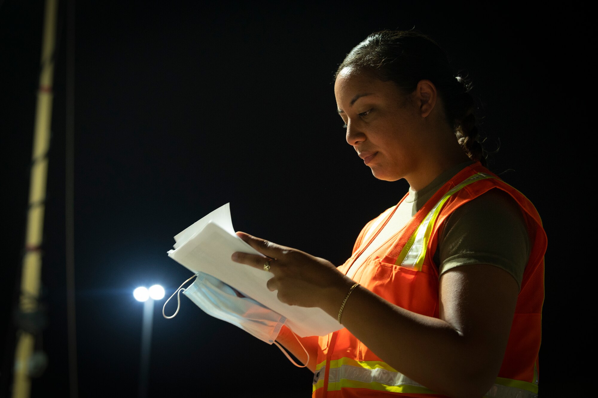 U.S. Air Force Staff Sgt. Paris Lauvale, 386th Expeditionary Force Support Squadron Personnel Support for Contingency Operations sustainments NCOIC, reviews a checklist before military personnel arrive to inprocess at Ali Al Salem Air Base, Kuwait, July 16, 2022. By being one of the largest PERSCO teams in the area of responsibility, they provide support to military personnel in transit across the AOR. (U.S. Air Force photo by Staff Sgt. Dalton Williams)