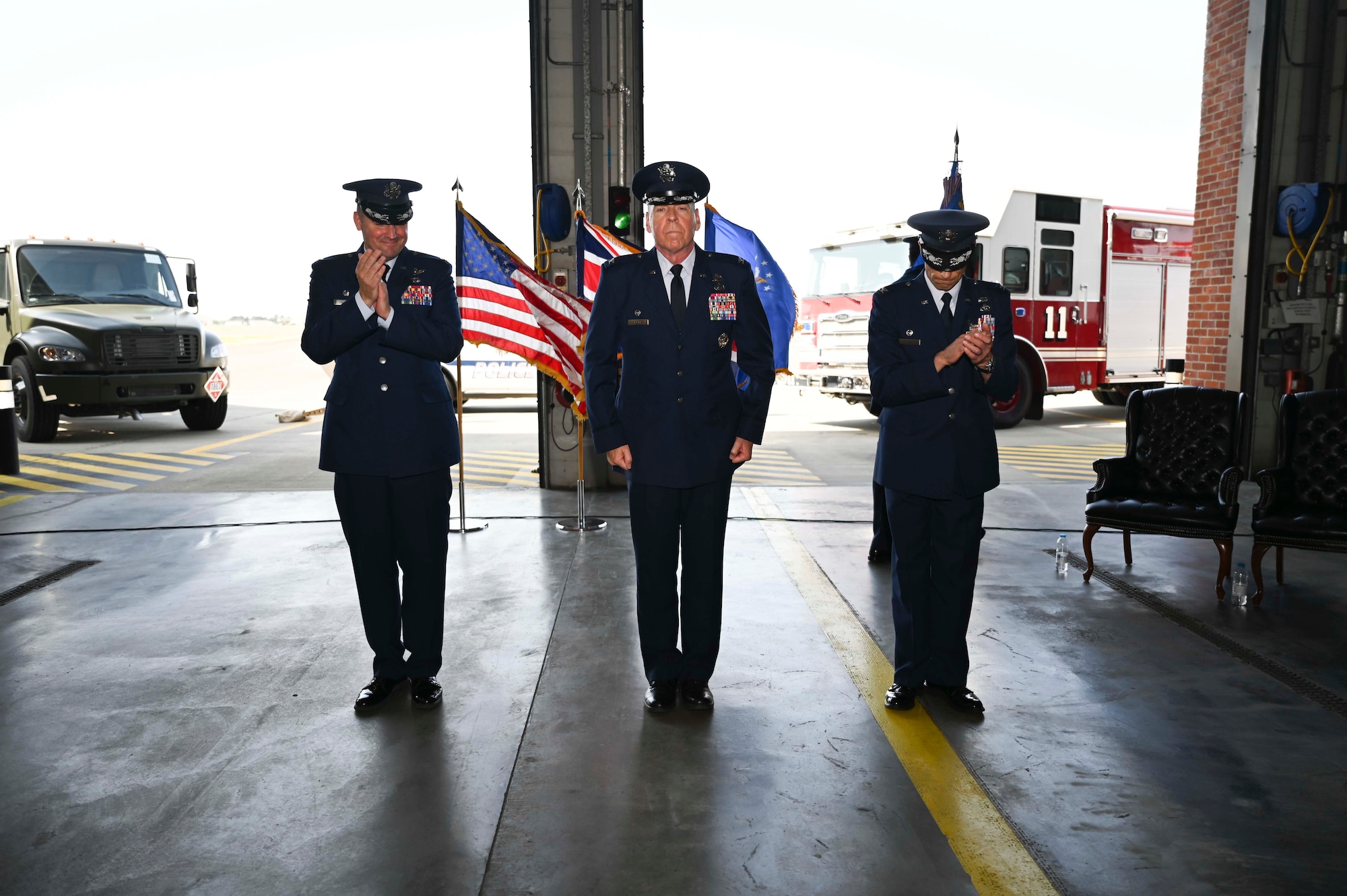 U.S. Air Force Col. Gene Jacobus, (left) 100th Air Refueling Wing commander, and Col. Aaron Wilt, (right) former 100th Mission Support Group commander, congratulate Col. Steven Clark, (middle) 100th MSG commander,Royal Air Force Mildenhall, England, July 20, 2022. Clark previously held a position as the director of cost and integration policy at the Pentagon in Washington D.C. (U.S. Air Force photo by Airman 1st Class Viviam Chiu)