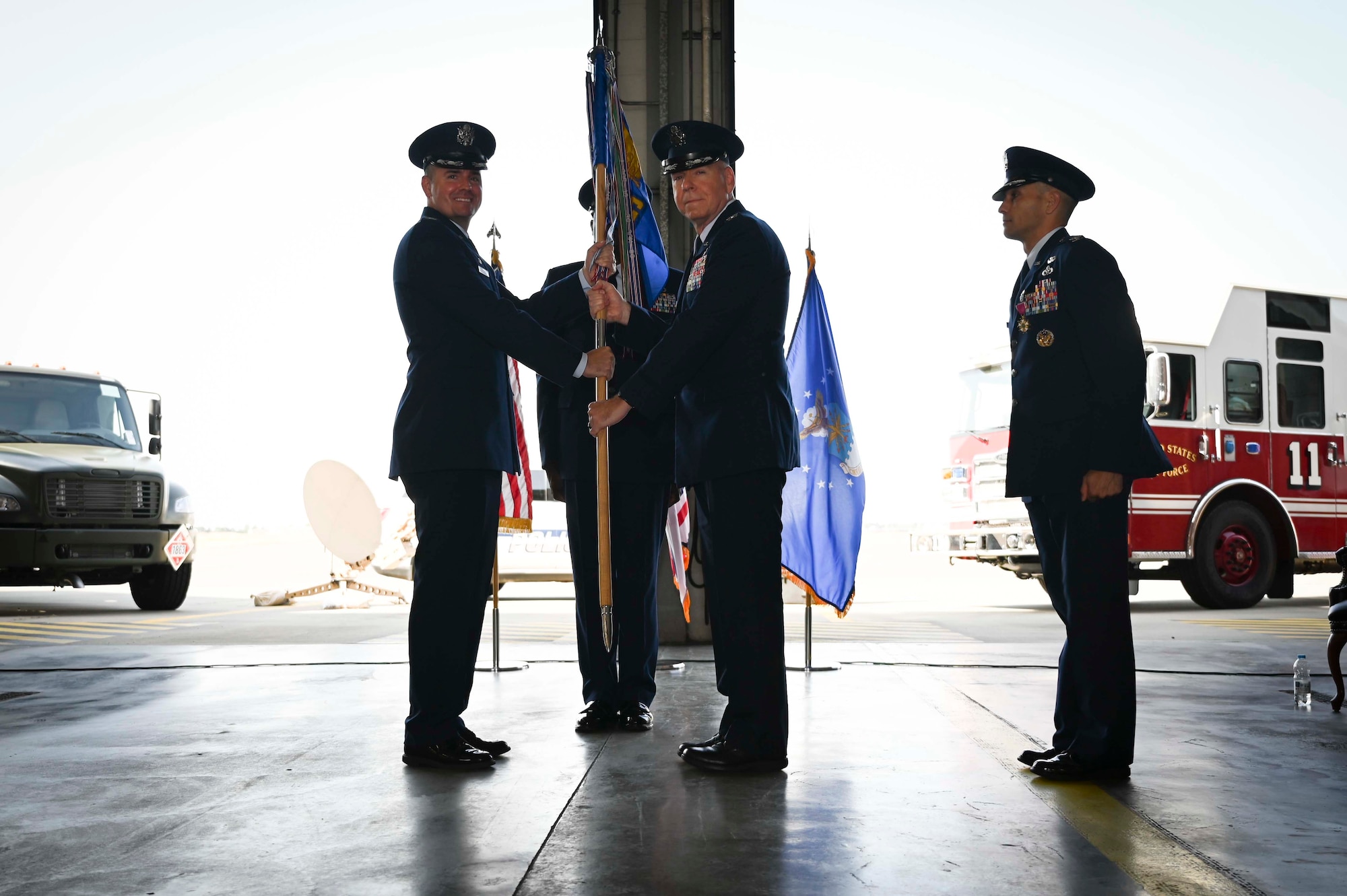 U.S. Air Force Col. Gene Jacobus, (left) 100th Air Refueling Wing commander, receives the 100th Mission Support Group’s guidon from Col. Aaron Wilt, (right) former 100th MSG commander, during the 100th MSG change of command at Royal Air Force Mildenhall, July 20, 2022. Clark passed the guidon to Jacobus to symbolize the relinquishing of command at the 100th MSG. (U.S. Air Force photo by Airman 1st Class Viviam Chiu)