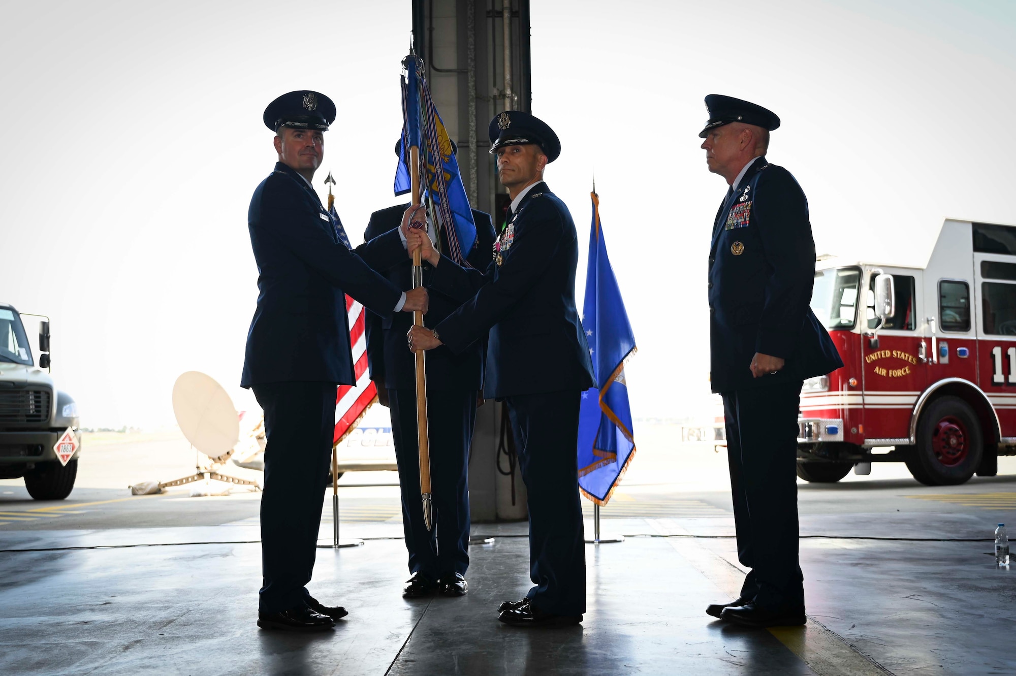 U.S. Air Force Col. Gene Jacobus, (left) 100th Air Refueling Wing commander, receives the 100th Mission Support Group’s guidon from Col. Aaron Wilt, (right) former 100th MSG commander, during the 100th MSG change of command at Royal Air Force Mildenhall, July 20, 2022. Clark passed the guidon to Jacobus to symbolize the relinquishing of command at the 100th MSG. (U.S. Air Force photo by Airman 1st Class Viviam Chiu)