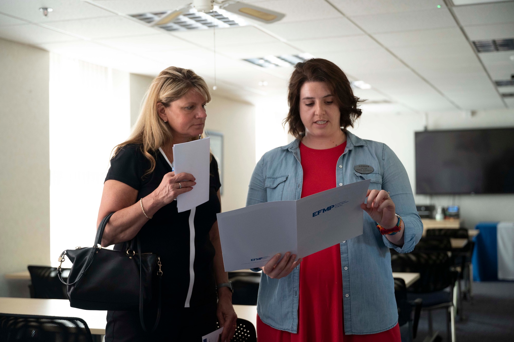 Mrs. Abby Johnson (right) briefs Mrs. Terrie Hecker (left) on the Airmen and Family Readiness Center’s resources, Royal Air Force Mildenhall, England, July 18, 2022. U.S. Air Force Gen. James Hecker, U.S. Air Forces in Europe - Air Forces Africa commander, and his spouse, Mrs. Hecker visited RAF Mildenhall during their initial command tour allowing them to get a first hand perspective of how the base is currently operating. (U.S. Air Force photo by Airman 1st Class Viviam Chiu)