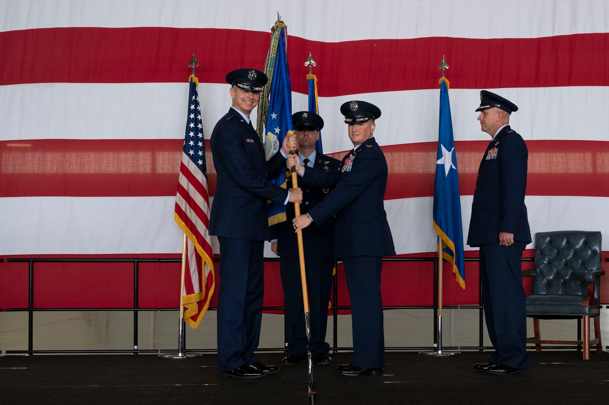 U.S, Air Force Col. Craig Prather, former 47th Flying Training Wing commander, turns over the 47th Flying Training Wing guidon to Maj. Gen. Craig Wills, 19th Air Force commander, during the 47th Flying Training Wing change of command ceremony at Laughlin Air Force Base, Texas, July 22, 2022. As commander, Davidson will oversee nearly 2,800 military and civilian personnel engaged in executing more than 61,000 aircraft sorties yearly in support of Laughlin's Specialized Undergraduate Pilot Training mission. (U.S. Air Force photo by Airman 1st Class Kailee Reynolds)