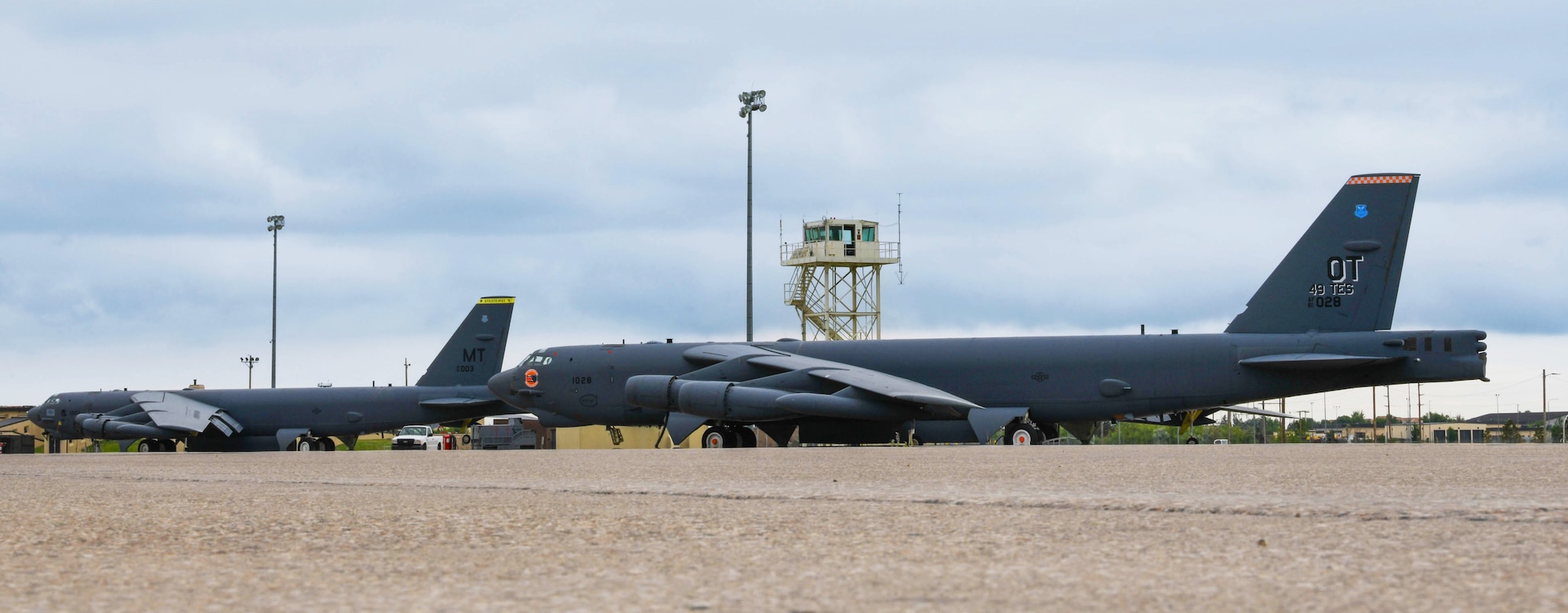 A B-52H Stratofortress assigned to the 69th Bomb Squadron is pictured alongside another B-52 assigned to the 49th Test and Evaluation Squadron on July 7, 2022. Both bombers participated in the B-52 Minot Roadshow event where the 49th TES, 340th Weapons Squadron, 69th BS, and 23rd BS executed combined sorties allowing for close collaboration and validation of Tactics, Techniques, and Procedures previously developed by the TES and WPS through integrated flight test. (U.S. Air Force photo by Airman 1st Class Alexander Nottingham)