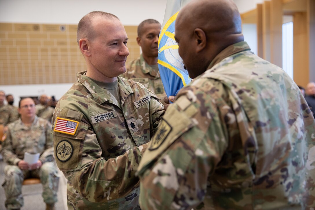 Soldier passes unit flag to new commander.