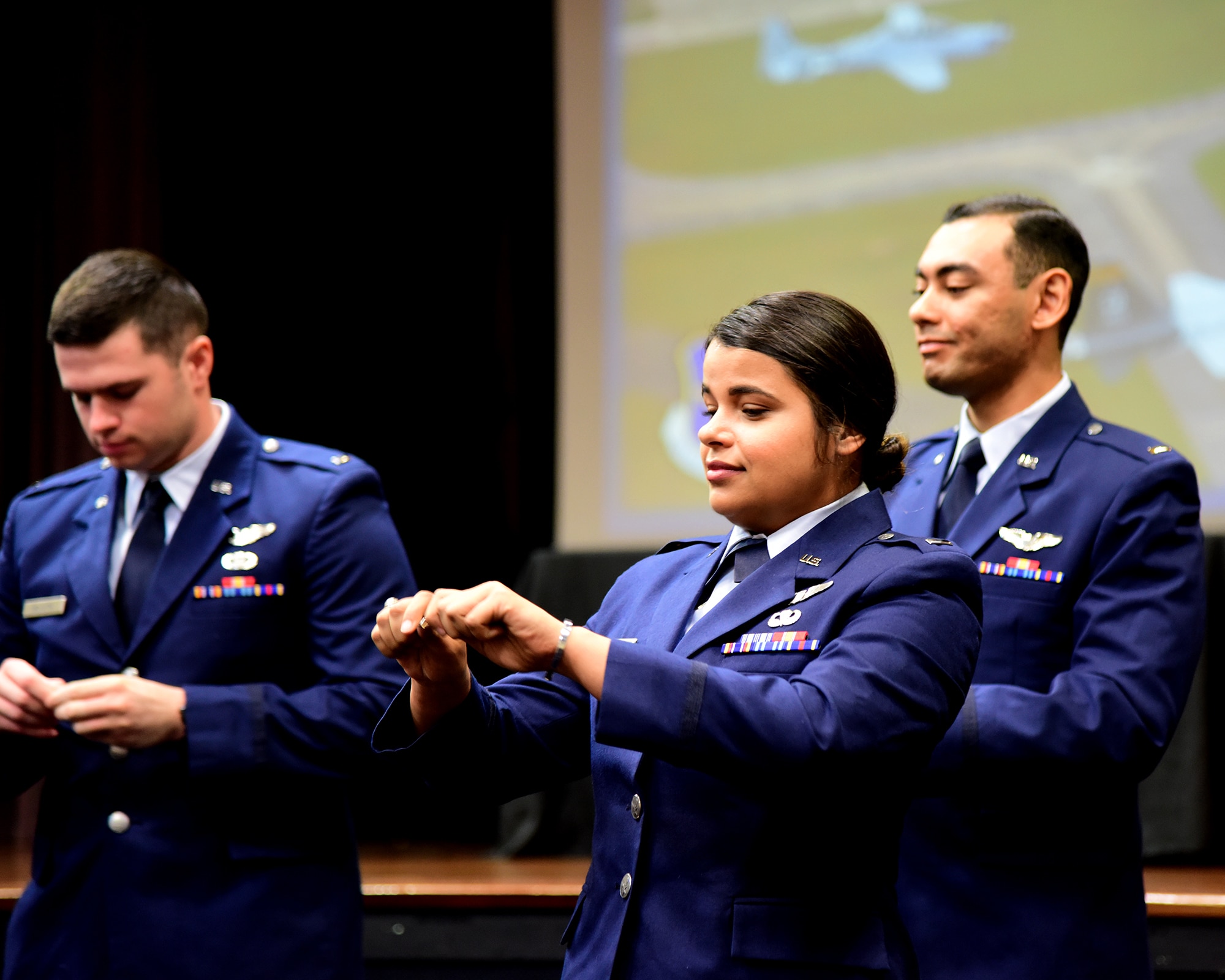 Pilots from UPT 2.5 break their first set of wings in half during graduation July 22,2022 on Columbus Air Force Base Miss. The breaking of the wings is a tradition where you give one half of your wings to a loved one and the other half stays with you.