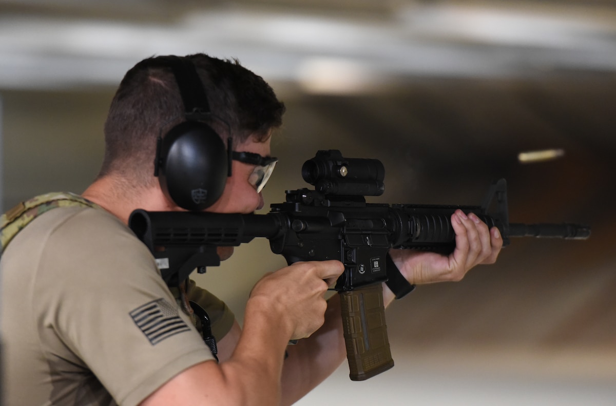 Senior Airman Paiden Carlisle, 88th Security Forces Squadron vehicle control official, fires an M4 carbine at the indoor firing range, Wright-Patterson Air Force Base, Ohio, July 22, 2022. The facility bought new targets made of a self-sealing lightweight polymer material that allows the bullet to pass through while also flipping it over to give the shooter instant visual feedback. (U.S. Air Force photo by Matthew Clouse)