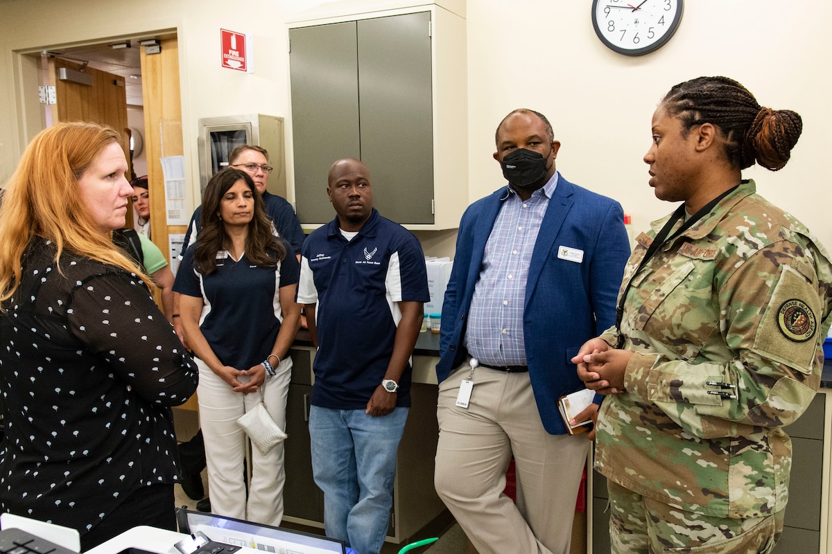 Master Sgt. Iesha Stanley, right, Armed Forces Medical Examiner System laboratory operations noncommissioned officer in charge, briefs honorary commanders and civic leaders on the various types of sample testing conducted at Dover Air Force Base, Delaware, July 22, 2022. The honorary commanders and civic leaders also visited the Fisher House, Center for Families of the Fallen, Joint Personal Effects Depot and Air Force Mortuary Affairs Operations. (U.S. Air Force photo by Roland Balik)
