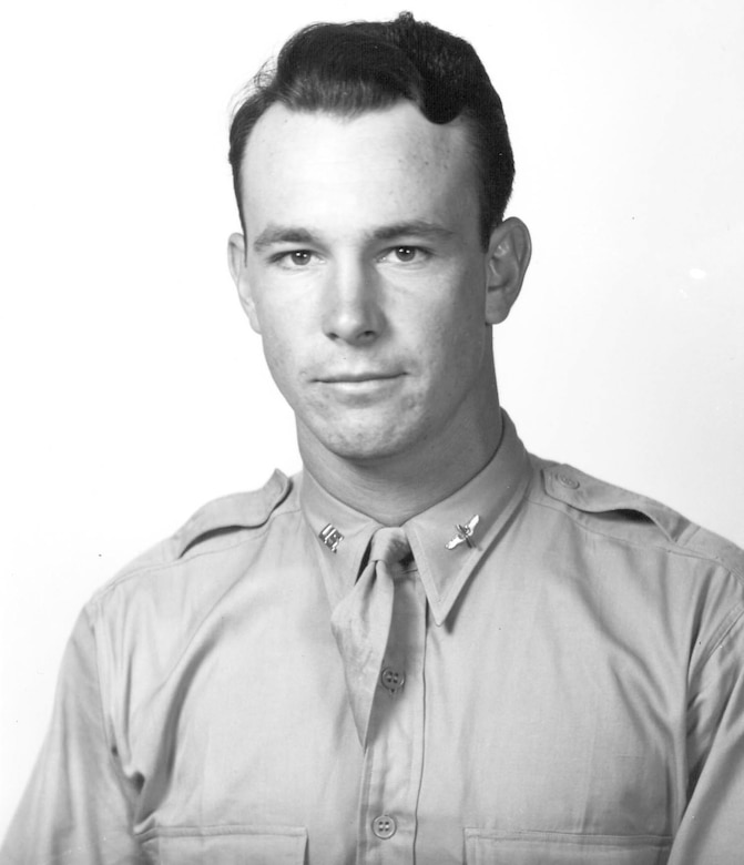 A man in uniform smiles for a photo.