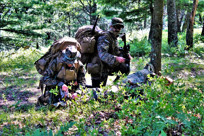 Hospital Corpsmen with the 2nd Battalion, 24th Marines, conducts a contact patrol with other Corpsmen and Marines on July 22, 2022, during training on North Post at Fort McCoy, Wis. The 2/24 is an infantry battalion based out of Chicago consisting of approximately 1,000 Marines and Sailors. The battalion falls under the 23rd Marine Regiment and the 4th Marine Division. The 2/24 is holding annual training at Fort McCoy.