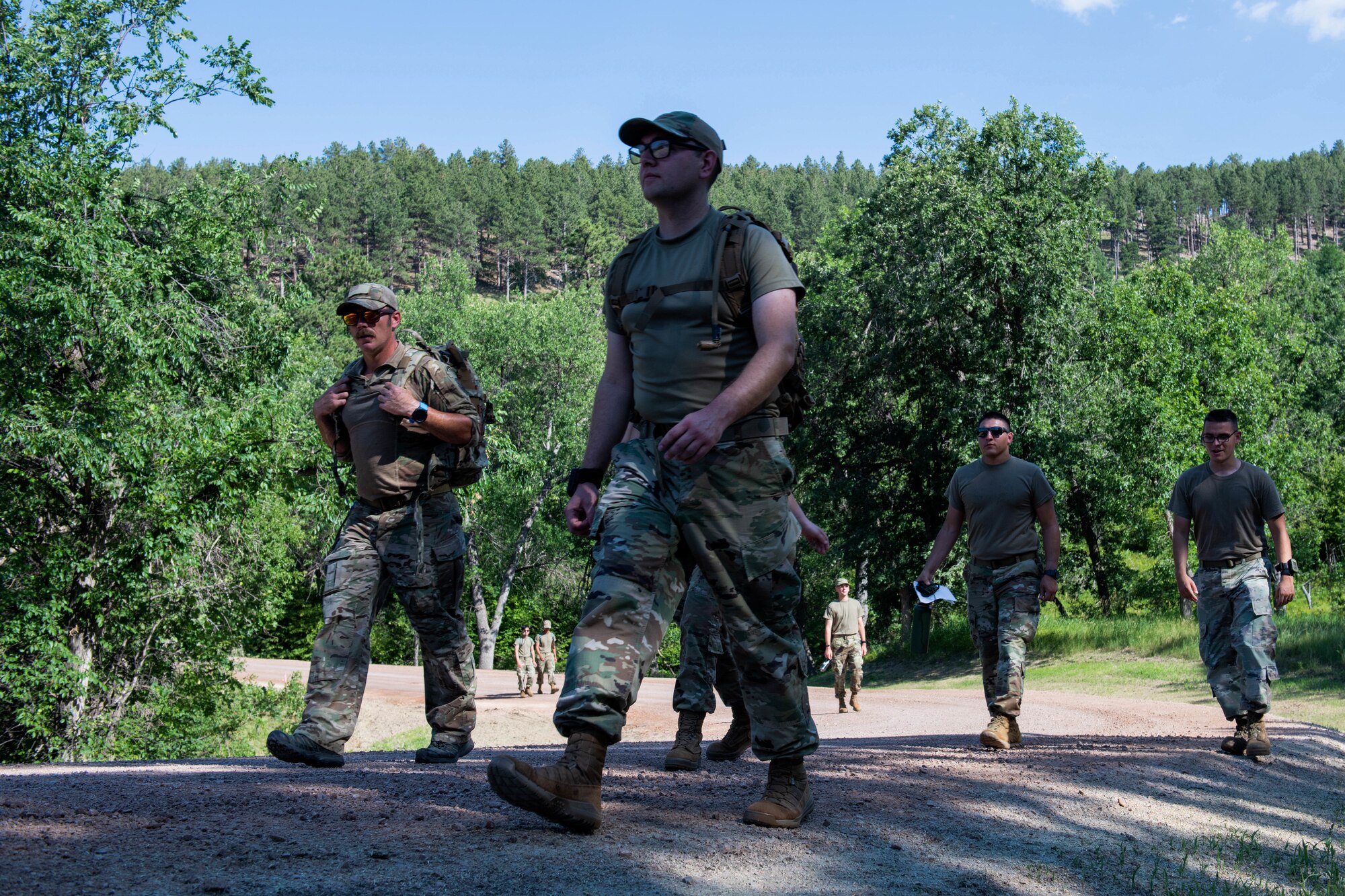 U.S. Air Force Airmen, assigned to the 28th Bomb Wing, complete the last-leg of a navigation hike during the first iteration of the Ellsworth Outdoor Survival Skills Course at the Fort Meade Training Area, S.D., July 21, 2022.
