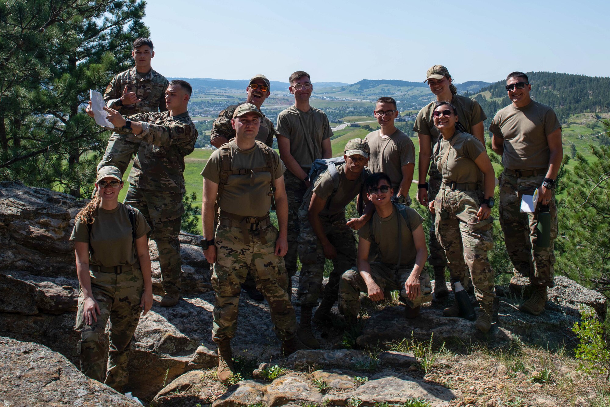 U.S. Air Force Airmen assigned to the 28th Bomb Wing pose for a group photo during the culminating event of the first Ellsworth Outdoor Survival Skills Course at the Fort Meade Training Area, S.D., July 21, 2022.