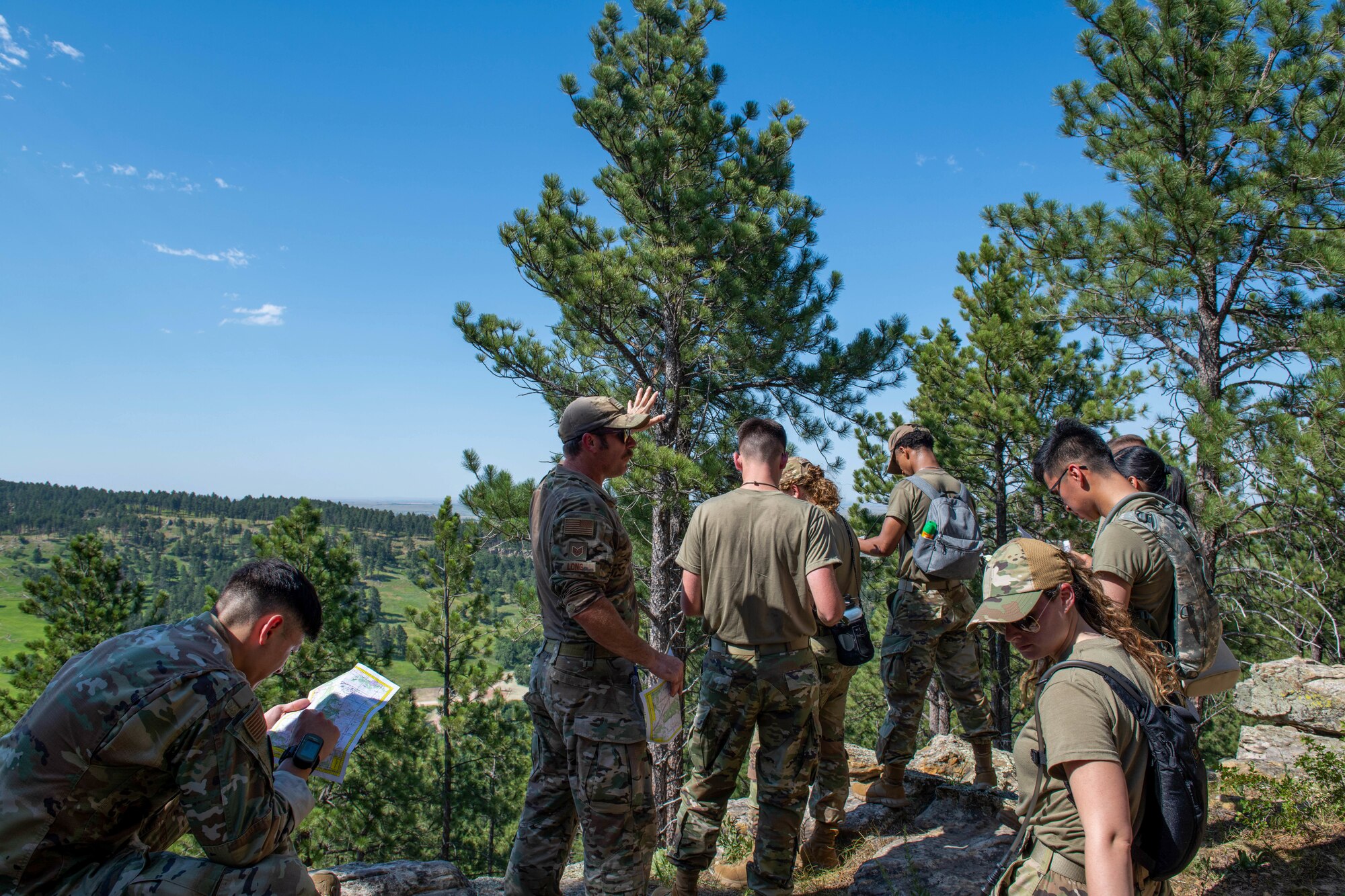 U.S. Air Force Airmen, assigned to the 28th Bomb Wing, learn navigation skills during the first iteration of the Ellsworth Outdoor Survival Skills Course at the Fort Meade Training Area, S.D., July 21, 2022.