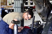 A mechanic works on a hot-pit refueling vessel.