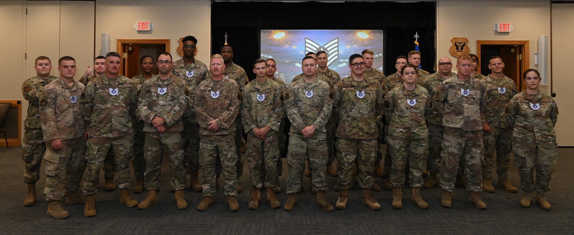 Technical Sgt. selects pose for a photo at the TSgt. release party at Whiteman Air Force Base, July 6, 2022. The 24 Airmen were selected for promotion for their excellent performance. (U.S. Air Force photo by Airman 1st Class Joseph Garcia)