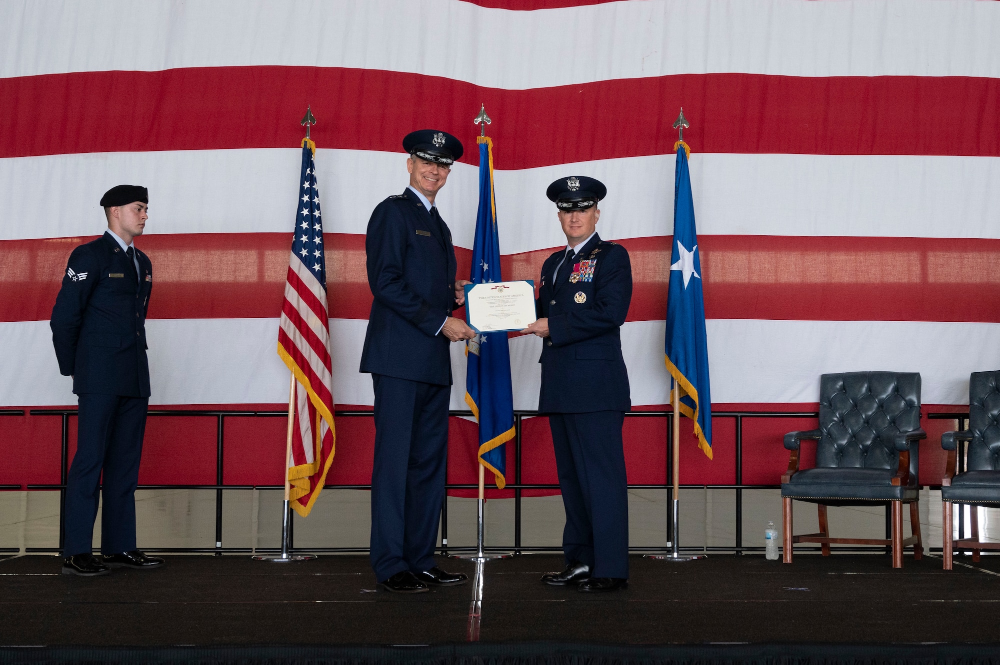 U.S. Air Force Maj. Gen. Craig Wills, 19th Air Force commander, presents an award to Col. Craig Prather, former 47th Flying Training Wing commander, during the 47th Flying Training Wing change of command ceremony at Laughlin Air Force Base, Texas, July 22, 2022. As commander, Davidson will oversee nearly 2,800 military and civilian personnel engaged in executing more than 61,000 aircraft sorties yearly in support of Laughlin’s Specialized Undergraduate Pilot Training mission. (U.S. Air Force photo by Airman 1st Class Kailee Reynolds)