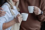 Couple holding coffee mugs