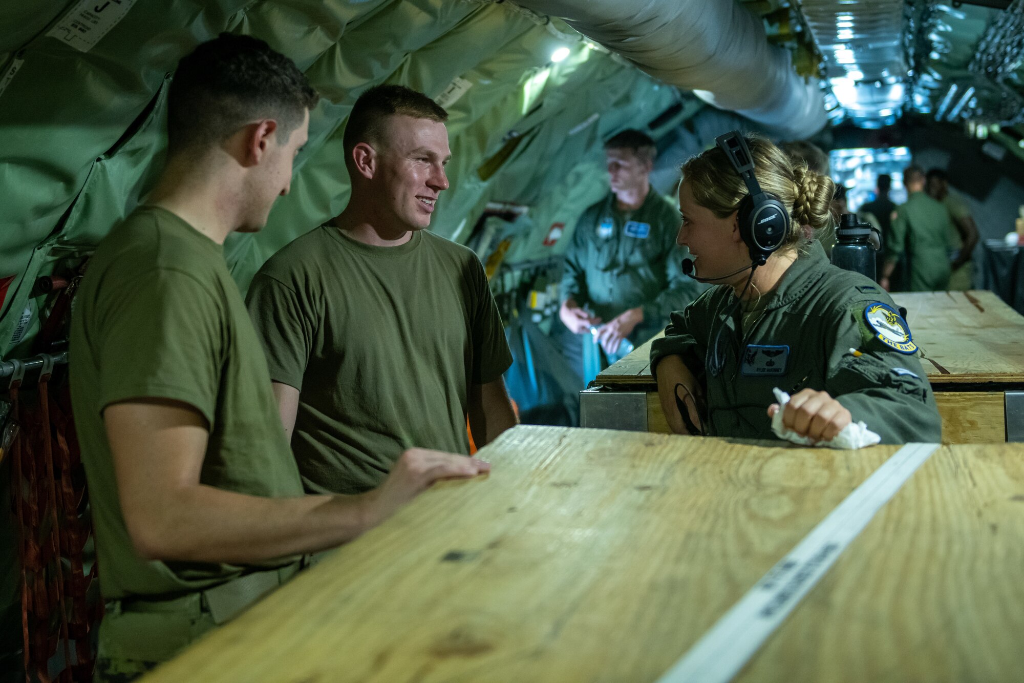 U.S. Air Force Airmen from Ellsworth Air Force Base, S.D., converse with an Iowa Air National Guardsman from the 185th Air Refueling Wing, Iowa Air National Guard, during a flight near Rapid City, S.D., July 21, 2022.