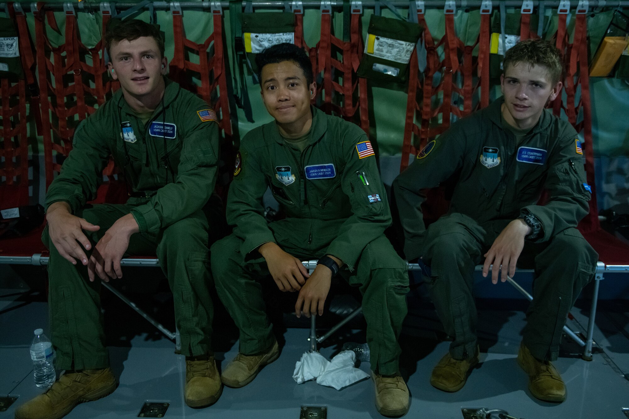 Three U.S. Air Force Academy cadets pose for a photo aboard a KC-135 Stratotanker assigned to the 185th Air Refueling Wing, Iowa Air National Guard, during an airborne refueling exercise near Rapid City, S.D., July 21, 2022.
