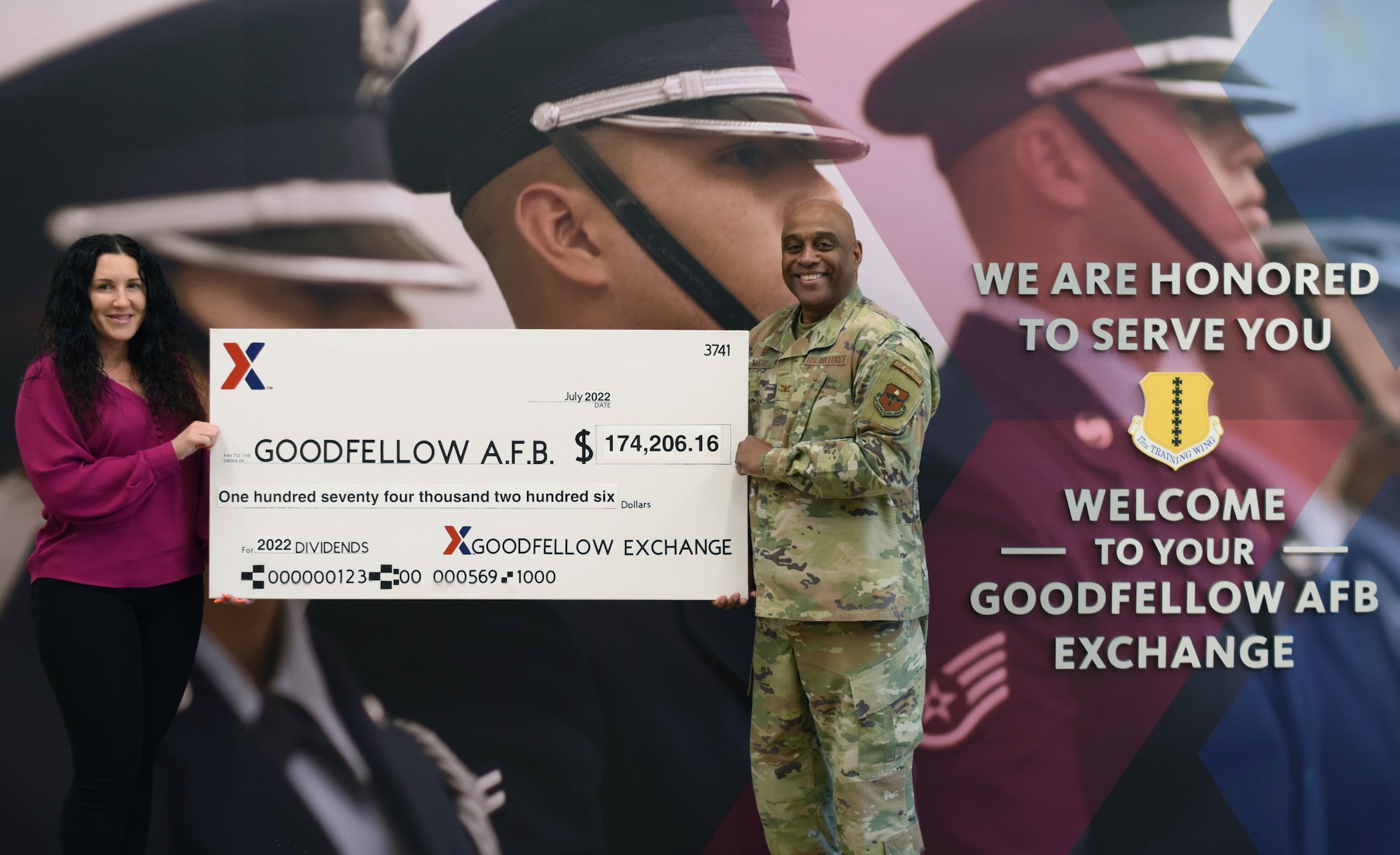 Bettina Cicirello-Frederick, Dyess/Goodfellow Exchange Army and Air Force Exchange Service general manager, presents U.S. Air Force Col. Eugene Moore, 17th Mission Support Group commander, a check at Goodfellow Air Force Base, Texas, July 25, 2022. The 2021 dividends from the Goodfellow Exchange were used to fund base-wide events that would be otherwise unfunded. (U.S. Air Force photo by Senior Airman Ethan Sherwood)