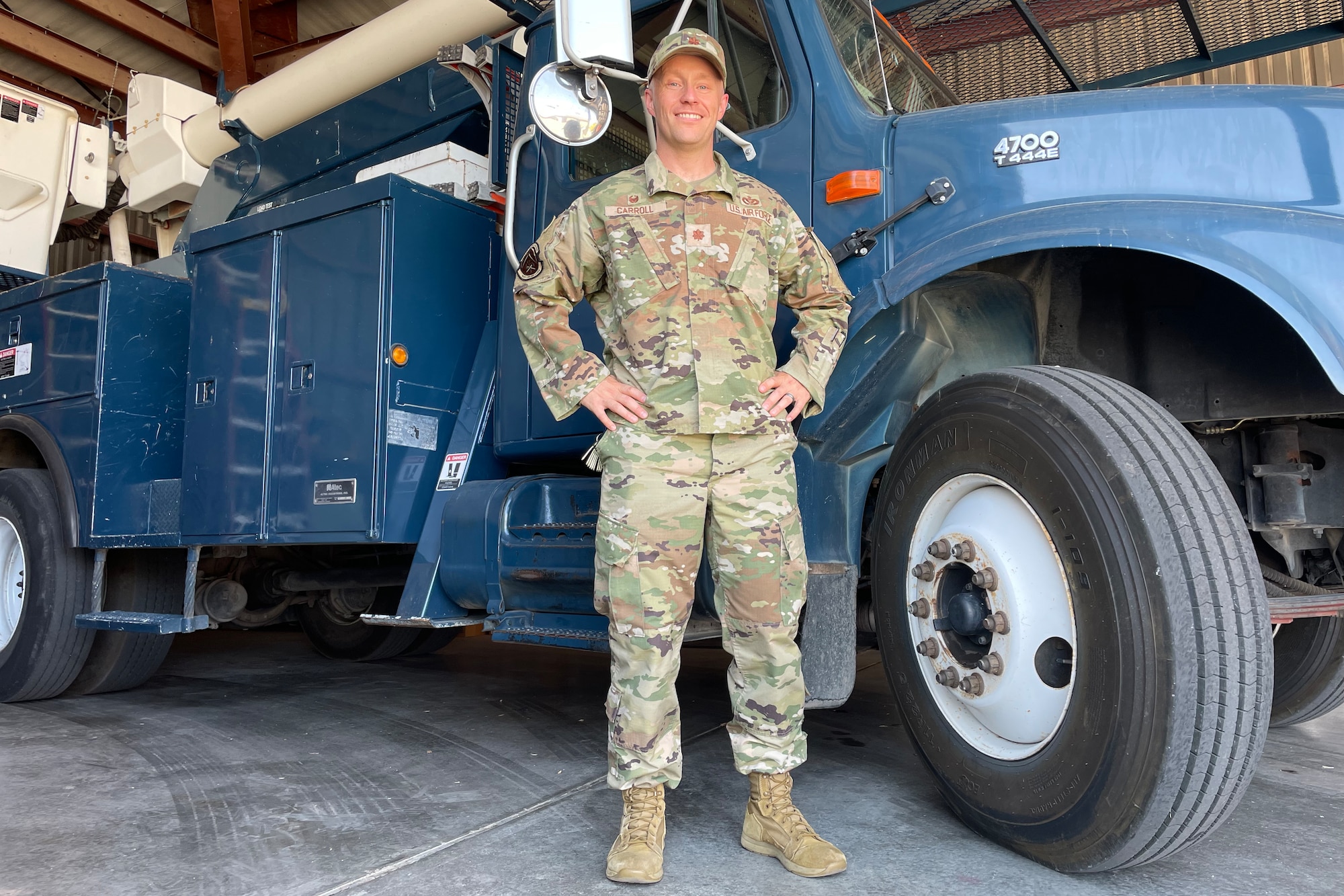 U.S. Air Force Maj. Joshua Carroll, 17th Civil Engineer Squadron commander, stands in front of a bucket truck, which contains a hydraulic lift used by 17th CE technicians at Goodfellow Air Force Base, Texas, July 18, 2022. Carroll took command June 17 and looks forward to leading efforts in building modernized tech training and combat support facilities. (U.S. Air Force photo by Senior Airman Abbey Rieves)