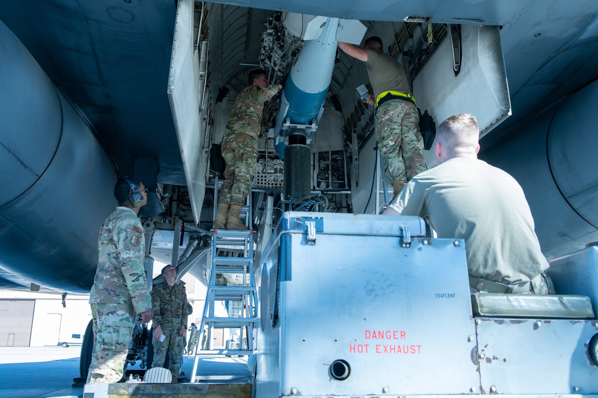 U.S. Air Force Airmen from the 28th Aircraft Maintenance Squadron load weapons into a B-1B Lancer during a weapons loading competition at Ellsworth Air Force Base, S.D., July 22, 2022.