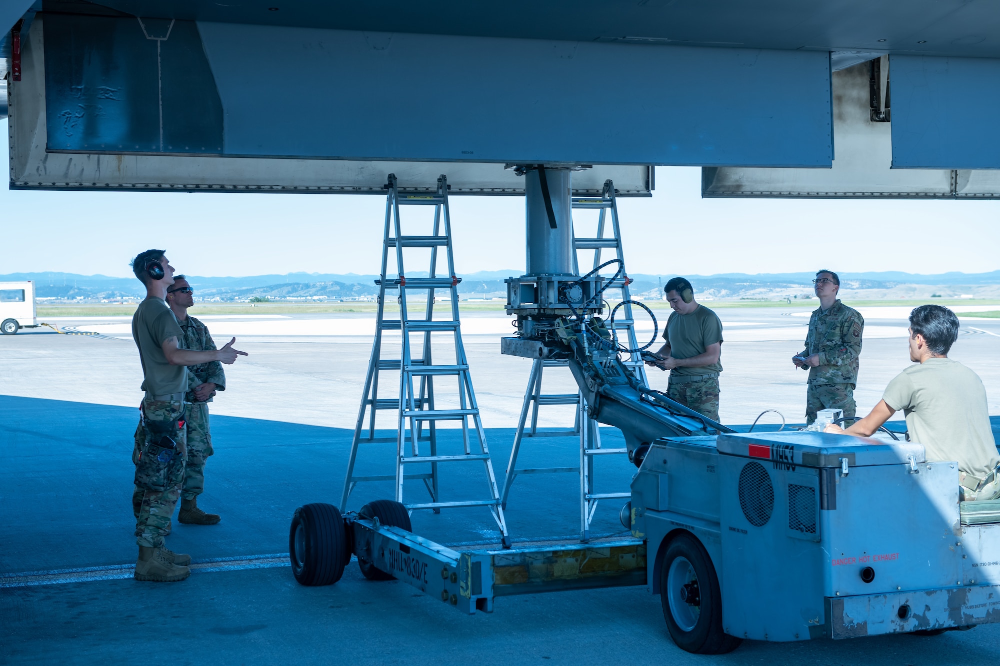 U.S. Air Force Airmen from the 28th Aircraft Maintenance Squadron load weapons into a B-1B Lancer during a weapons loading competition at Ellsworth Air Force Base, S.D., July 22, 2022.