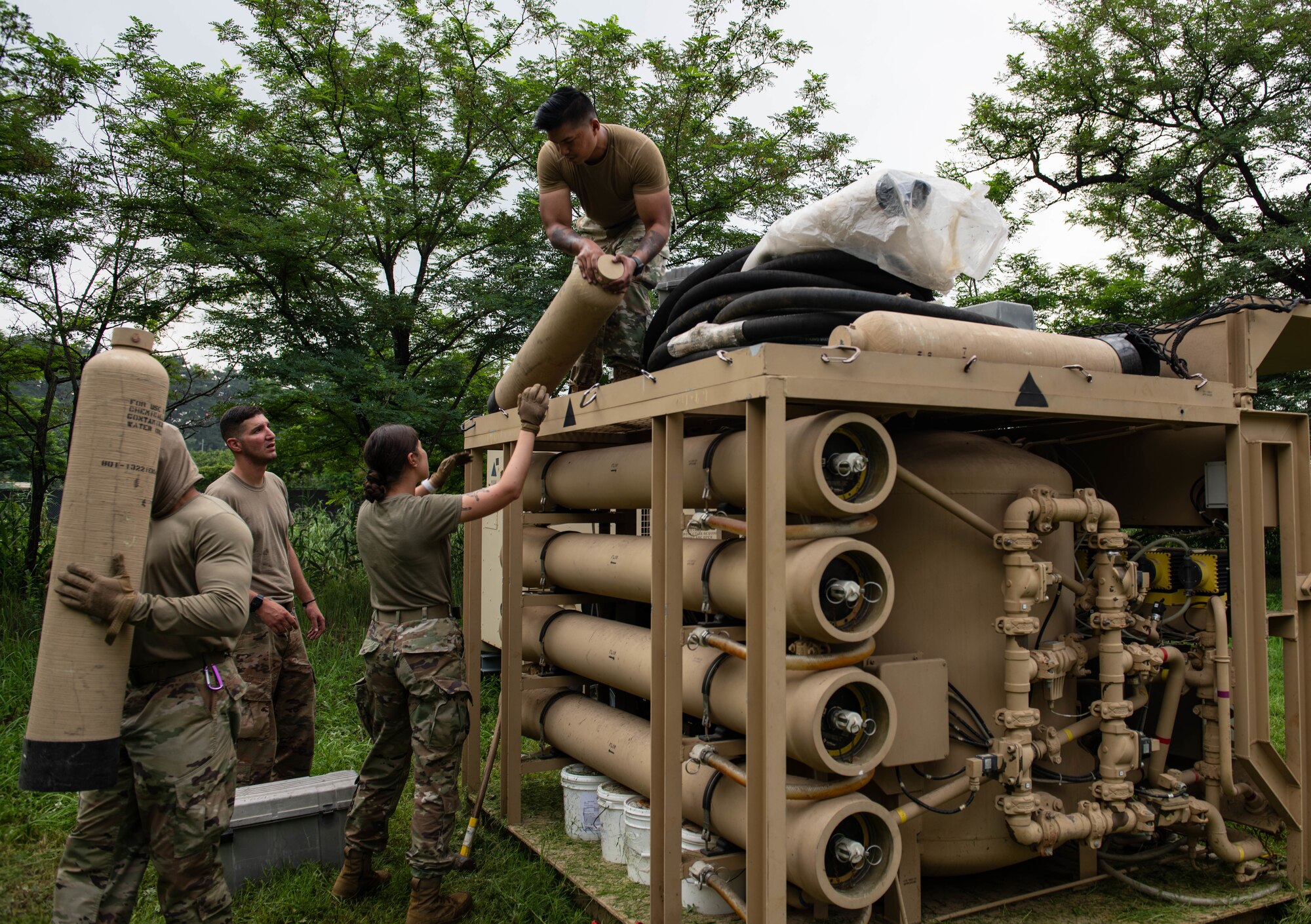 Airmen work on a machine that