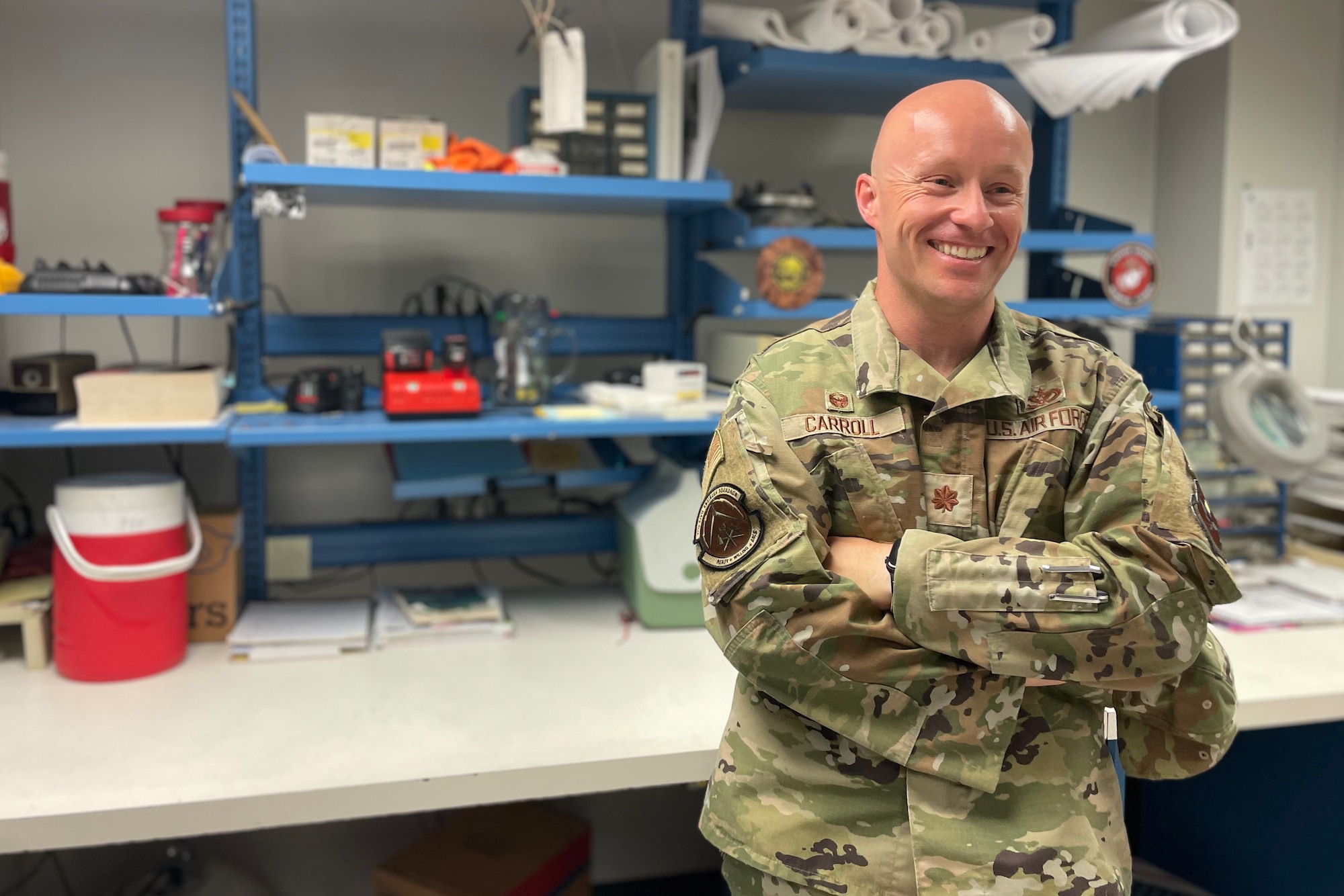 U.S. Air Force Maj. Joshua Carroll, 17th Civil Engineer Squadron commander, smiles while visiting members of his unit, at Goodfellow Air Force Base, Texas, July 18, 2022. The 17th CES is comprised of 176 civilian and military personnel operating and maintaining 2.8 million square feet of facilities valued at $1 billion and supporting a base population of 5,500 military, civilians and students. (U.S. Air Force photo by Senior Airman Abbey Rieves)