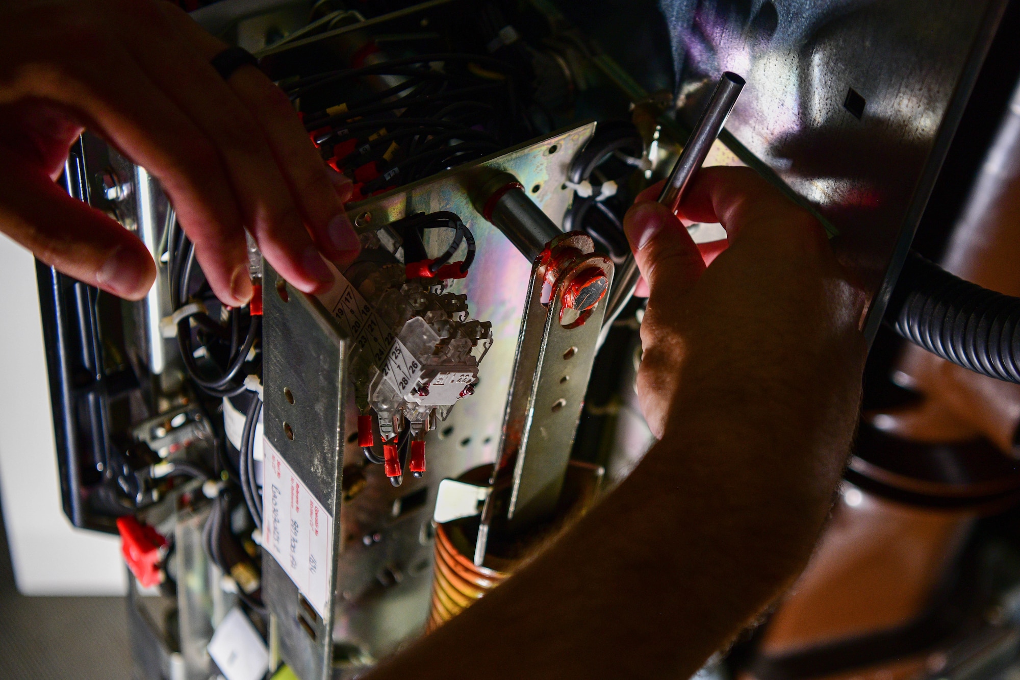 U.S. Air Force Tech. Sgt. Jacob Lanzer, Civil Engineer Maintenance, Inspection and Repair Team craftsman, applies grease to a high voltage circuit breaker during routine maintenance at Aviano Air Base, Italy, June 21, 2022. The frequency of inspection, maintenance and testing for circuit breakers should be one to three years, dependent upon the severity of duty encountered by the circuit breaker. (U.S. Air Force photo by Senior Airman Brooke Moeder)