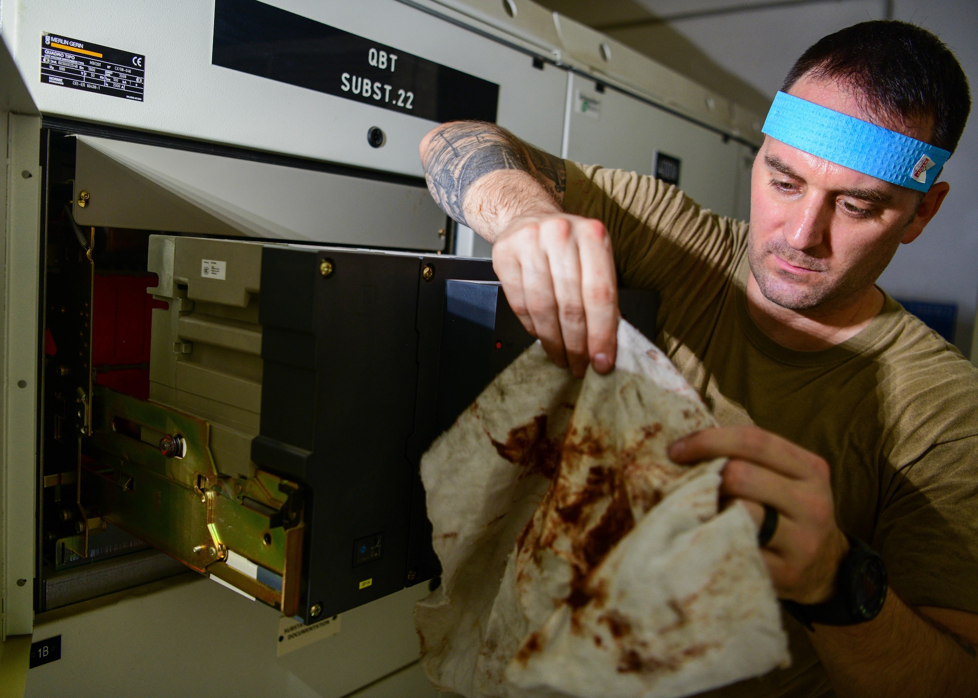 U.S. Air Force Master Sgt. Blake Meyer, Civil Engineer Maintenance, Inspection and Repair Team electrical NCO in charge cleans a low voltage circuit breaker during routine maintenance at Aviano Air Base, Italy, June 21, 2022. Electrical teams provide emergency and routine troubleshooting, data logging, power analysis and repair on electrical distribution equipment and systems. (U.S. Air Force photo by Senior Airman Brooke Moeder)