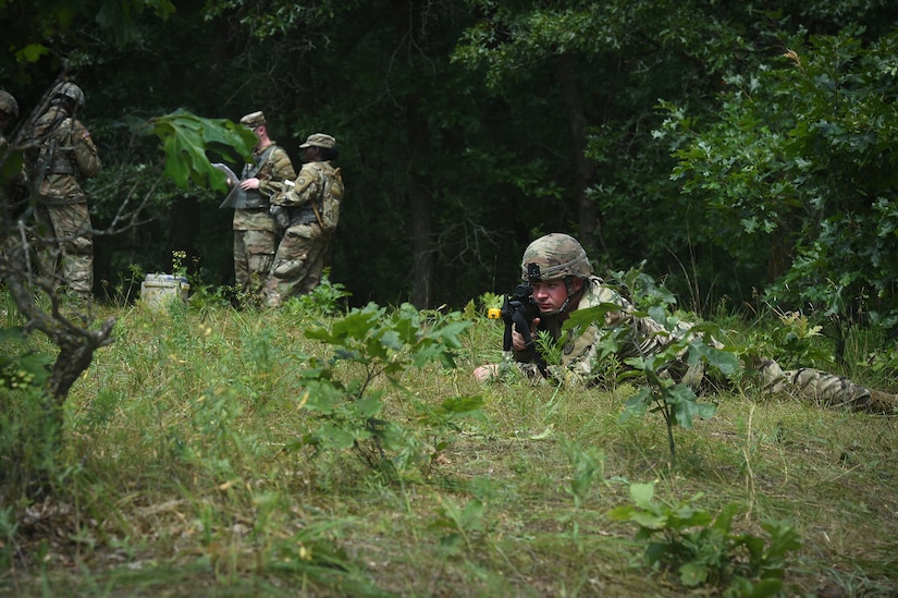 U.S. Army Reserve Pfc. Tylor Coulson, truck driver for the 630th Transportation Company, provides security while his squad receives its Operation Order during Warrior Exercise 78 at Fort McCoy, Wisconsin, July 19, 2022.