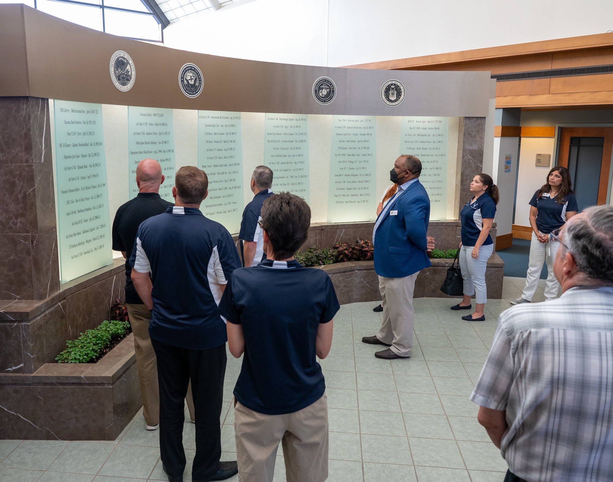 Dover Air Force Base honorary commanders view the memorial wall during their orientation at Air Force Mortuary Affairs Operations at Dover Air Force Base, Delaware, July 22, 2022. The Dover AFB Honorary Commanders program helps members of the community understand the importance of the base’s and the Air Force's mission. (U.S. Air Force photo by Jason Minto)