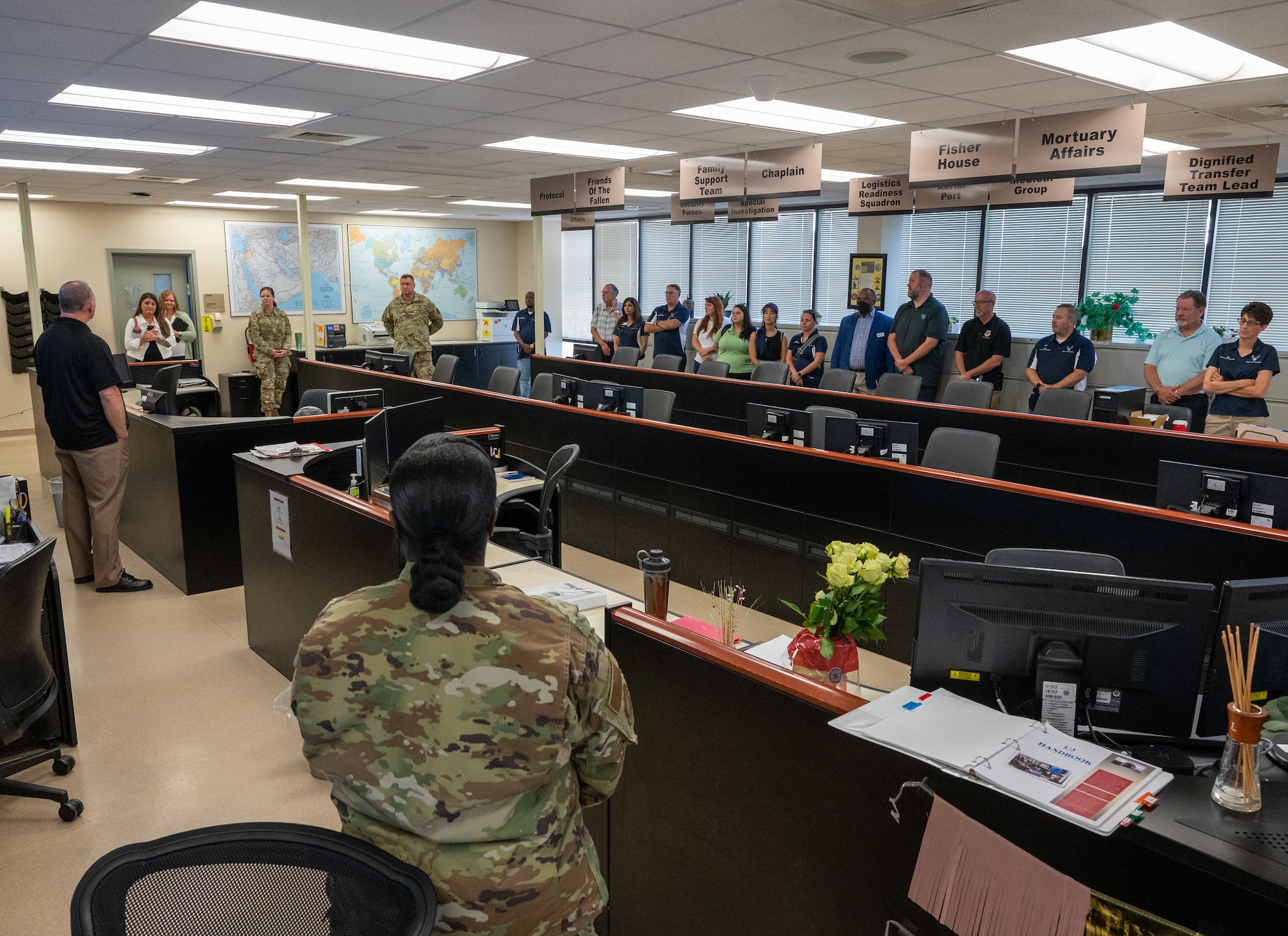 Dover Air Force Base honorary commanders receive a brief on Air Force Mortuary Affairs Operations Command, Control and Communication 24/7 Operation Center at Dover Air Force Base, Delaware, July 22, 2022. The Dover AFB Honorary Commanders program helps members of the community understand the importance of the base’s and the Air Force's mission. (U.S. Air Force photo by Jason Minto)