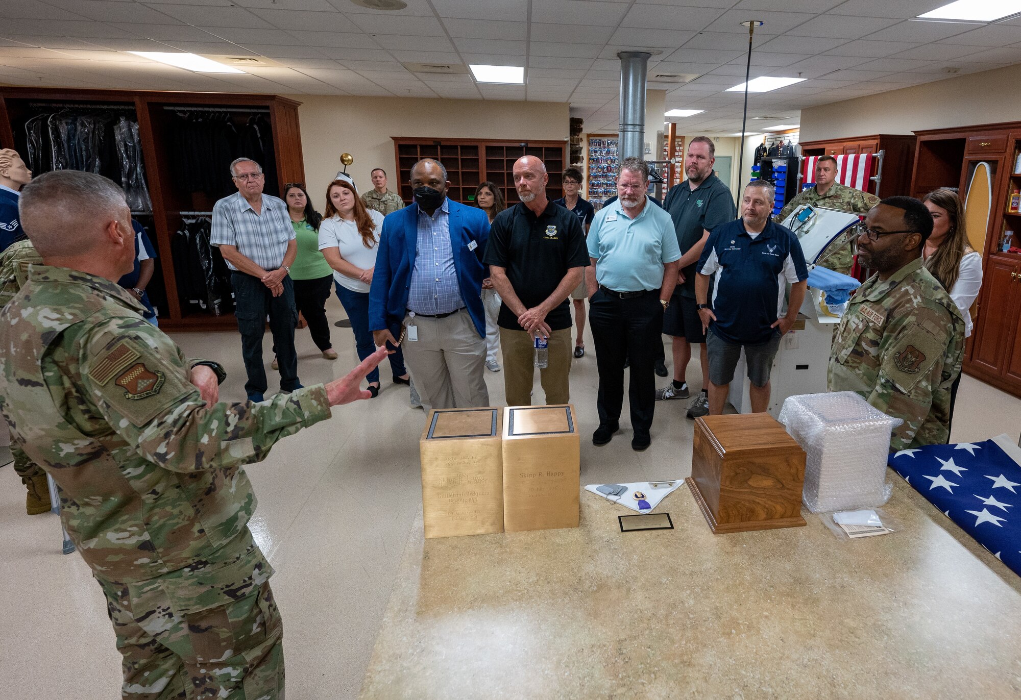 Dover Air Force Base honorary commanders learn about the urn engraving process during their visit to Air Force Mortuary Affairs Operations uniform's section at Dover Air Force Base, Delaware, July 22, 2022. The Dover AFB Honorary Commanders program helps members of the community understand the importance of the base’s and the Air Force's mission. (U.S. Air Force photo by Jason Minto)