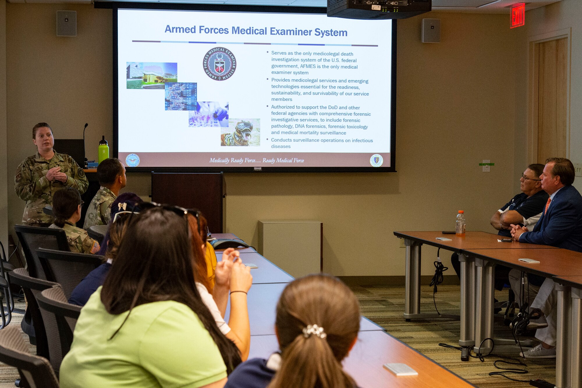 Col. Alice Briones, left, Armed Forces Medical Examiner System director, briefs honorary commanders and civic leaders on the mission and history of AFMES at Dover Air Force Base, Delaware, July 22, 2022. The honorary commanders and civic leaders also visited the Fisher House, Center for Families of the Fallen, Joint Personal Effects Depot and Air Force Mortuary Affairs Operations. (U.S. Air Force photo by Roland Balik)