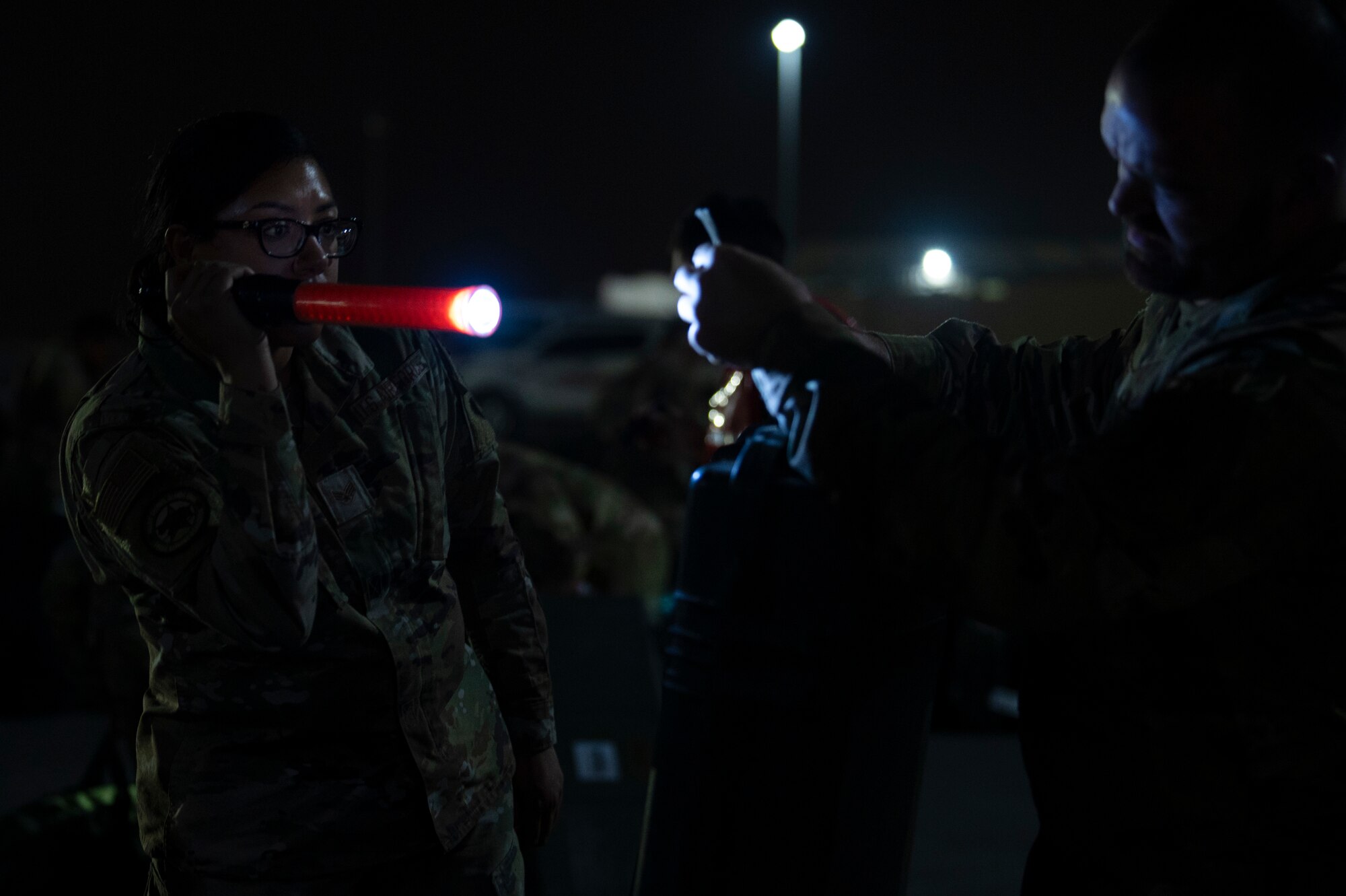 U.S. Air Force Senior Airman Krisha Contreras, 386th Expeditionary Force Support Squadron Personnel Support for Contingency Operations sustainments technician, assists with luggage identification at Ali Al Salem Air Base, Kuwait, July 16, 2022. By being one of the largest PERSCO teams in the area of responsibility, they provide support to military personnel in transit across the AOR. (U.S. Air Force photo by Staff Sgt. Dalton Williams)