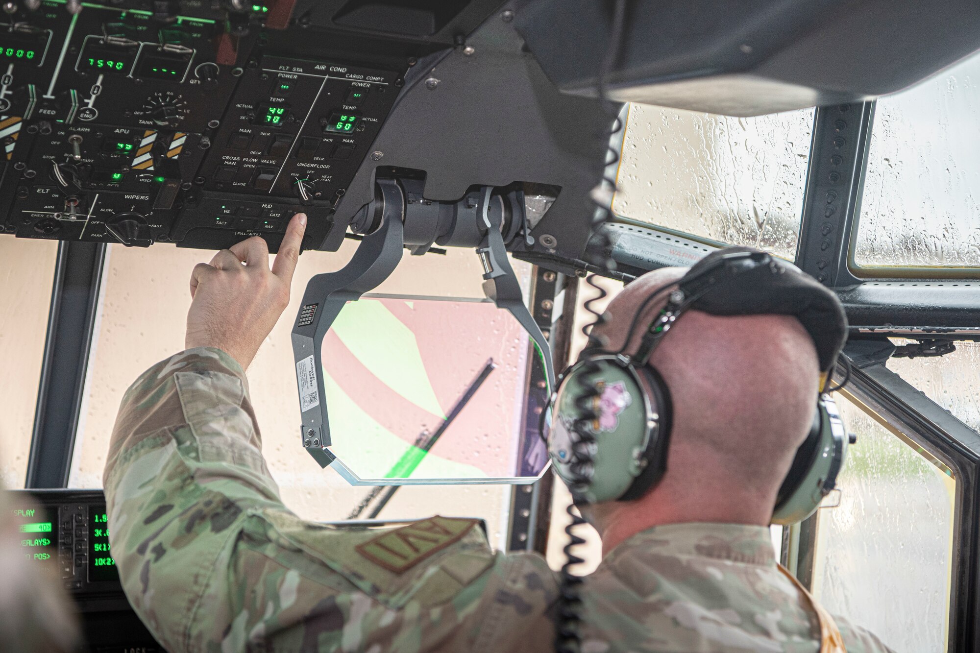 Senior Airman Nathan Collins, 374th Aircraft Maintenance Squadron C-130J instrument and flight control systems journeyman, performs an operational check of a head-up display at Yokota Air Base, Japan, July 26, 2022.