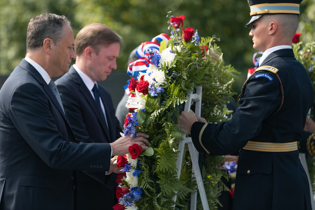 On July 27, 2022, a Marine Band trumpeter rendered "Taps" during a wreath laying ceremony for the dedication of the Korean War Veterans Memorial Wall of Remembrance. Second gentleman Doug Emhoff lays a wreath during the ceremony. (U.S. Marine Corps photo by Staff Sgt. Chase Baran/released)
