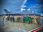 Airmen assigned to the Vermont Air National Guard’s 158th Fighter Wing hold a Green Mountain Battle flag in front of their U.S. Air Force F-35A Lighting II after successfully completing an Agile Combat Employment exercise to support the NATO air shielding mission at Amari Air Base, Estonia, July 15, 2022. Exercises and engagements in the European area of responsibility demonstrate U.S. commitment to the security and stability in this region.