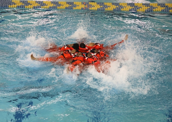 Civil Service Mariners (CIVMAR) demonstrate a 'sunburst' formation during an abandon ship scenario at the Military Sealift Command Training Center East on Joint Base Langley-Fort Eustis, Virginia