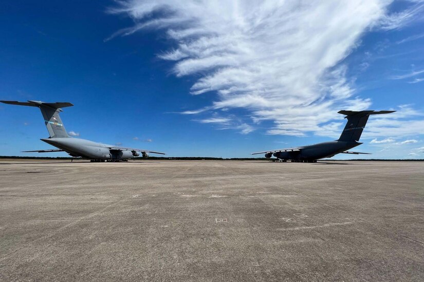 Two large planes sit on the tarmac.